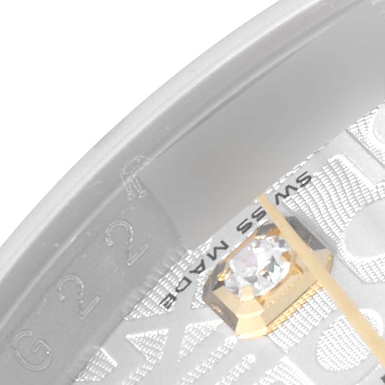 Close-up of the Rolex Datejust 116233 Men's Steel and Gold (two tone) Silver Dial 116233 Men's Steel and Gold (two tone) Silver Dial watch dial, showing a diamond marker and partial text "SWISS MADE."