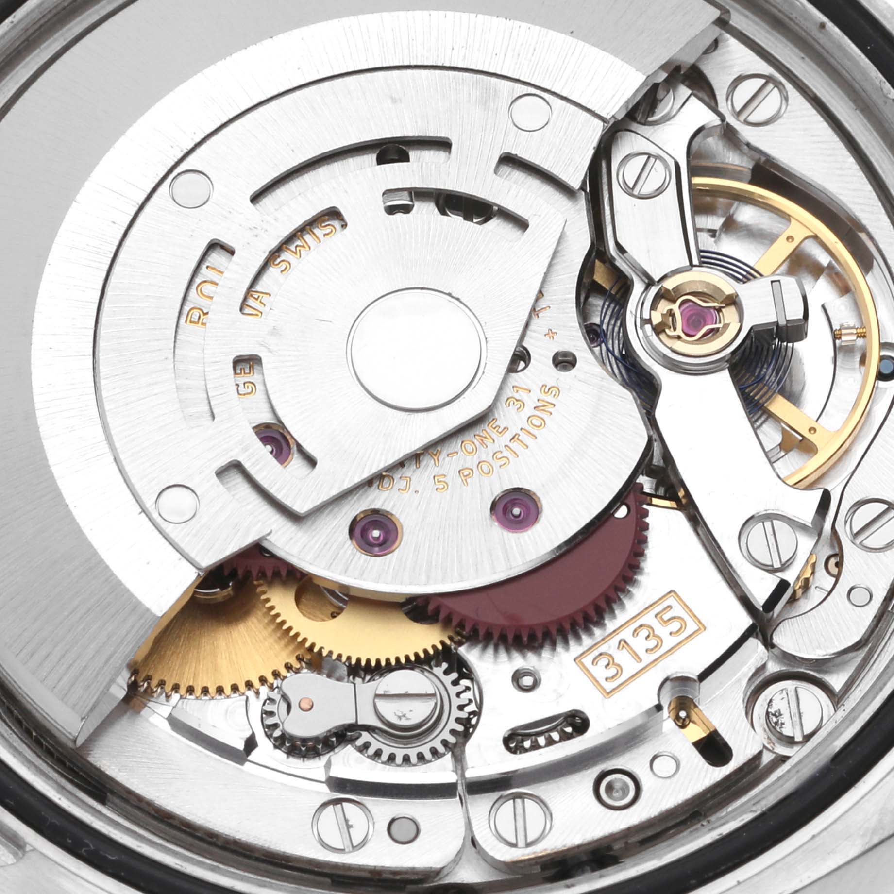 The image shows a close-up view of the movement mechanism of a Rolex Datejust 116233 Men's Steel and Gold (two tone) Silver Dial 116233 Men's Steel and Gold (two tone) Silver Dial watch, highlighting gears and intricate components.