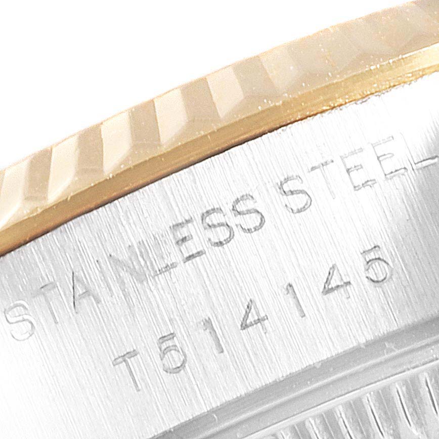 This close-up image shows the engraved serial number and stainless steel marking on the bezel of a Rolex Datejust 69173 Women
s Steel and Gold (two tone) Champagne Dial 69173 Women
s Steel and Gold (two tone) Champagne Dial watch.