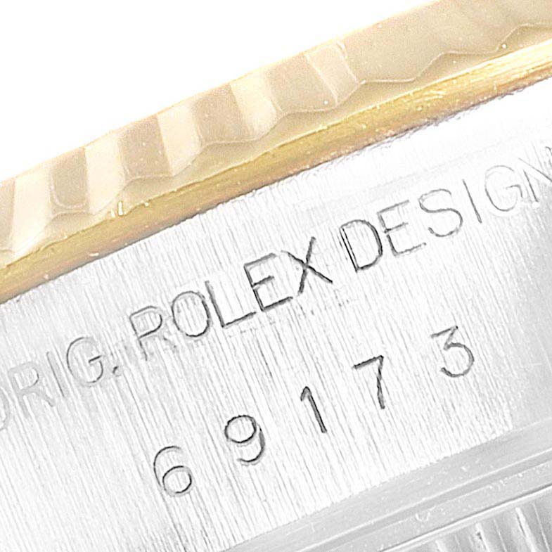 This image shows a close-up of the case side of a Rolex Datejust 69173 Women
s Steel and Gold (two tone) Champagne Dial 69173 Women
s Steel and Gold (two tone) Champagne Dial watch, highlighting the bezel and engraved model number.