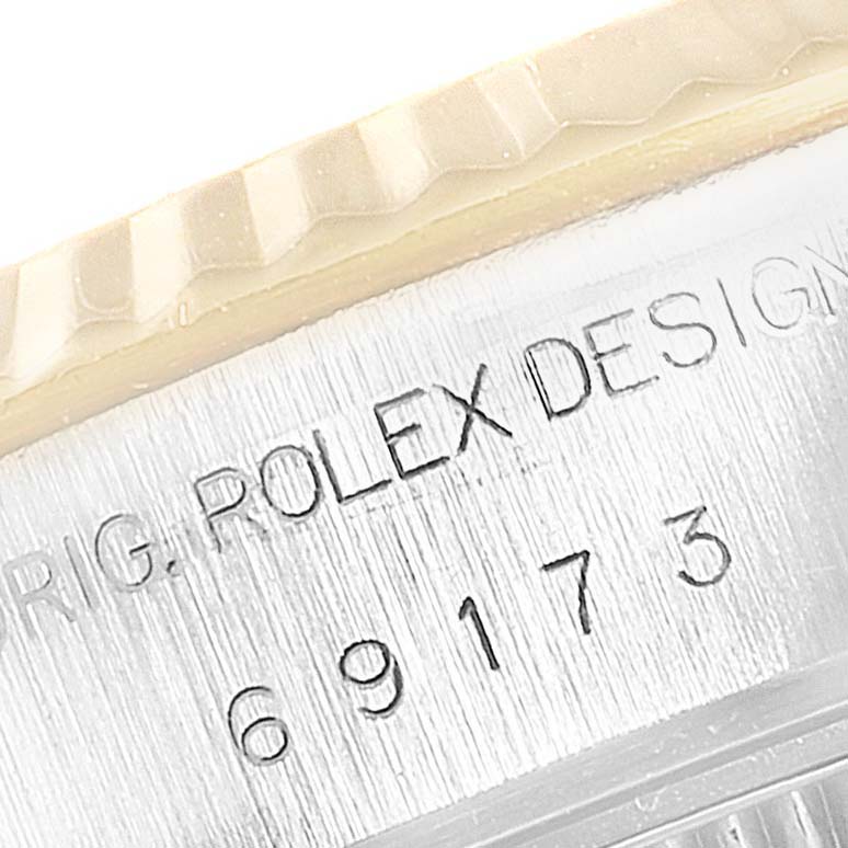 The image shows a close-up angle of the fluted bezel and engravings on the case of the Datejust model by Rolex.