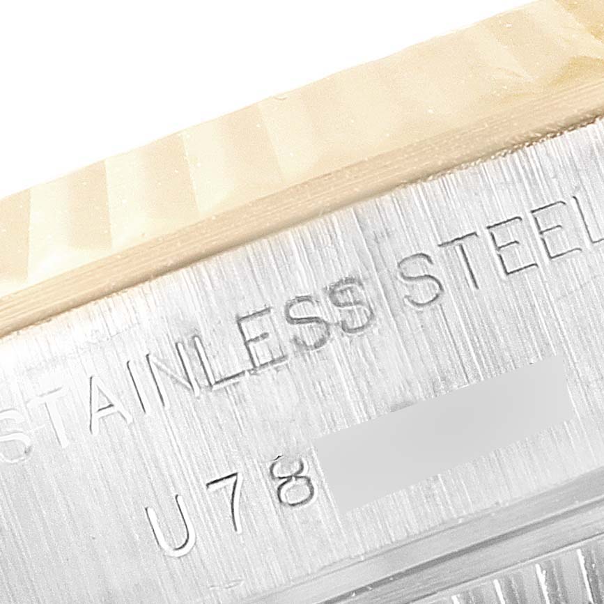 This close-up image shows the "STAINLESS STEEL" engraving on the side of a Rolex Datejust 69173 Women
s Steel and Gold (two tone) Champagne Dial 69173 Women
s Steel and Gold (two tone) Champagne Dial watch.