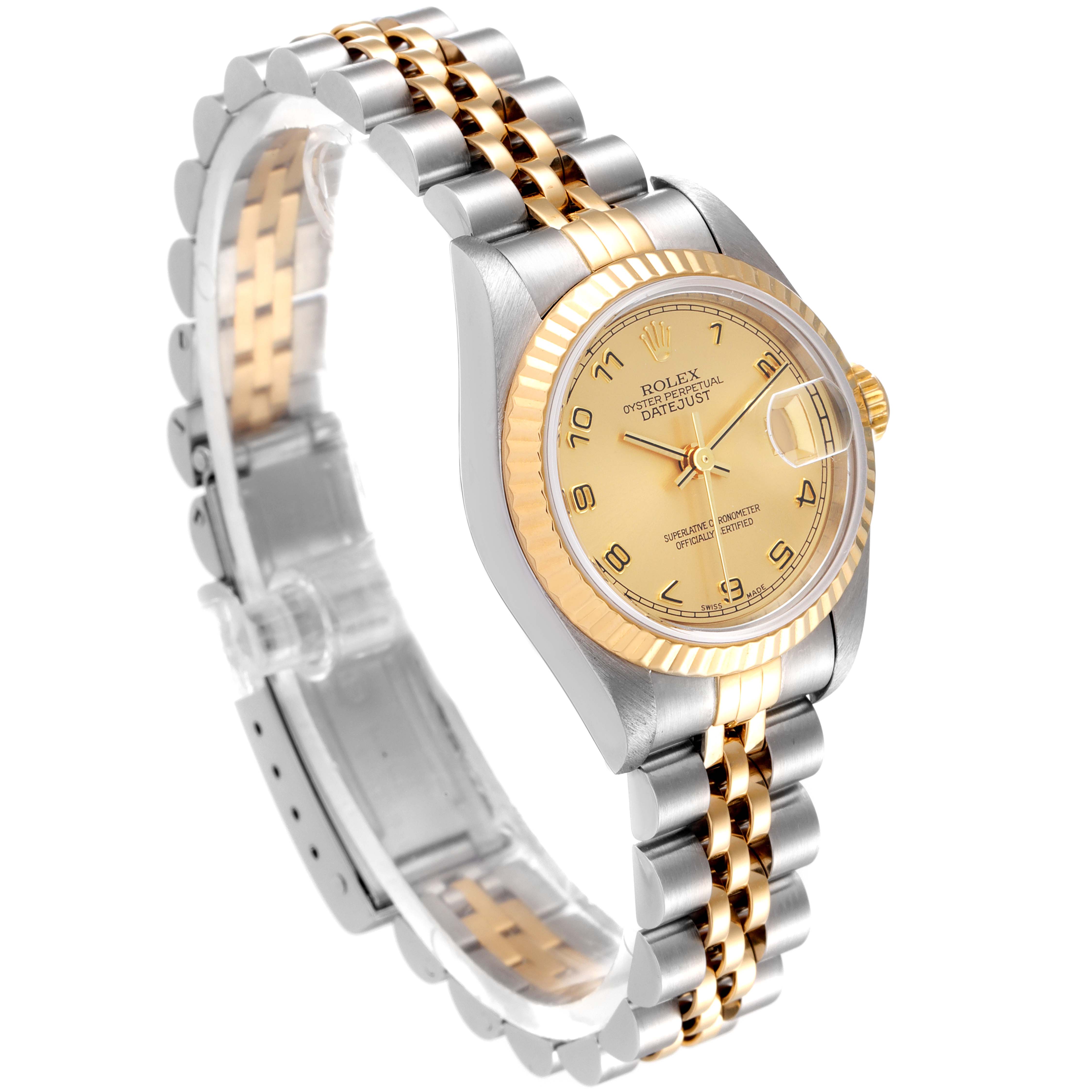 The image shows a Rolex Datejust 69173 Women
s Steel and Gold (two tone) Champagne Dial 69173 Women
s Steel and Gold (two tone) Champagne Dial watch from a three-quarter angle, highlighting its dial, bezel, and two-tone bracelet.