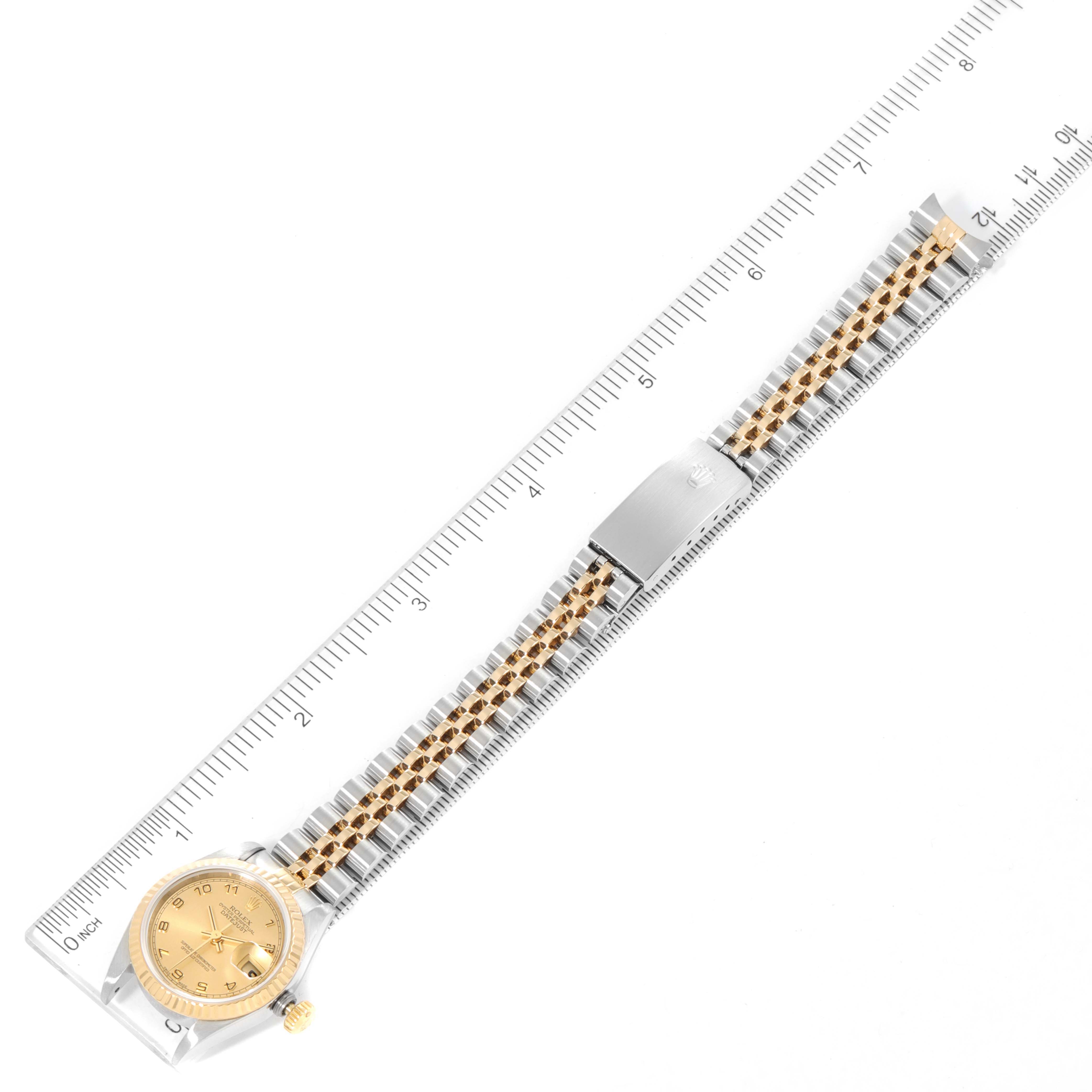 The image shows a Rolex Datejust 69173 Women
s Steel and Gold (two tone) Champagne Dial 69173 Women
s Steel and Gold (two tone) Champagne Dial watch laid flat, measured with a ruler, displaying the face, bezel, bracelet, and clasp.