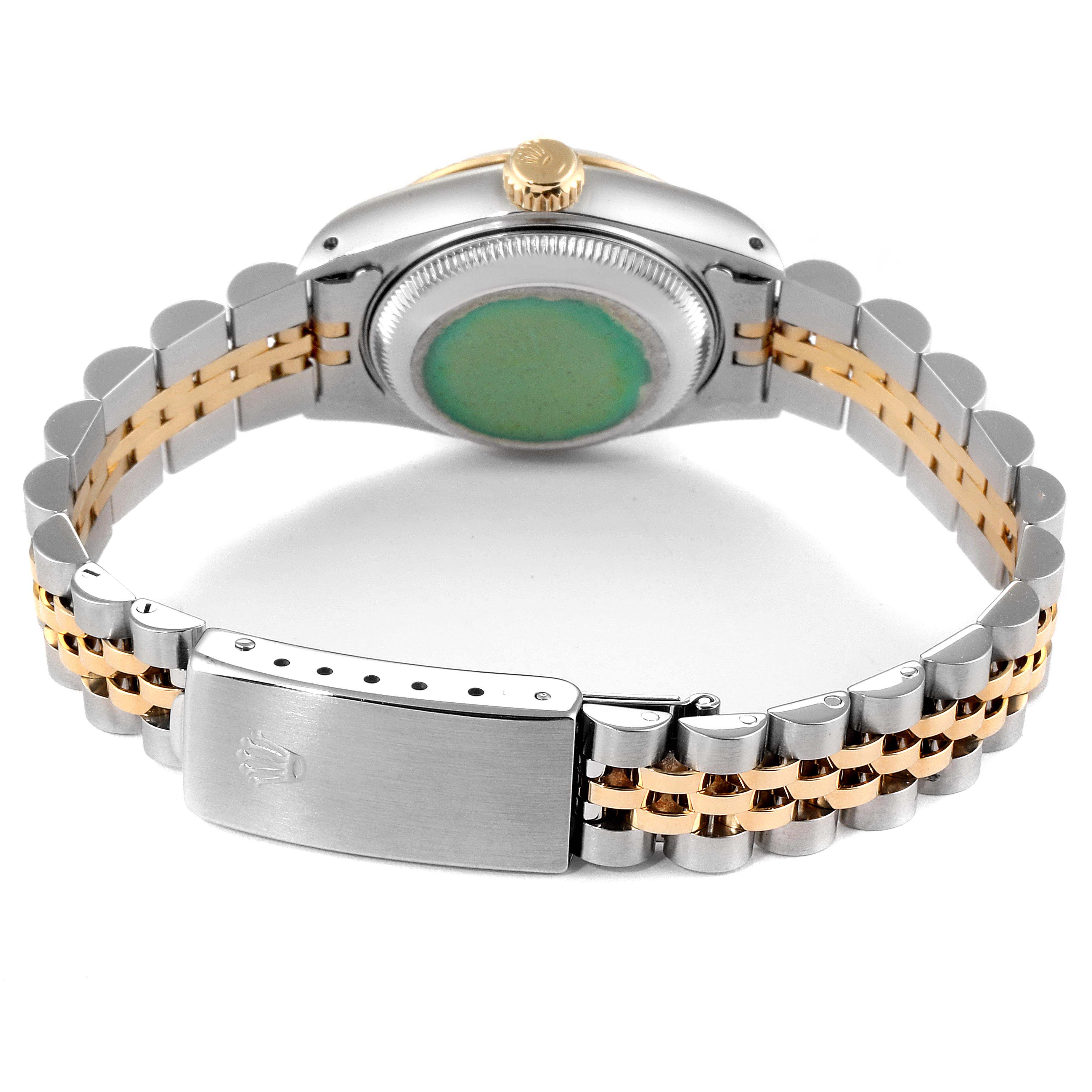 The image shows the back view of a Rolex Datejust 69173 Women
s Steel and Gold (two tone) Beige Dial 69173 Women
s Steel and Gold (two tone) Beige Dial watch, highlighting the case back, crown, and two-tone bracelet with the clasp.