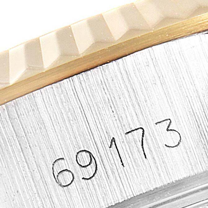 This image shows the model number and fluted bezel of a Rolex Datejust 69173 Women
s Steel and Gold (two tone) Beige Dial 69173 Women
s Steel and Gold (two tone) Beige Dial watch at a close-up angle.