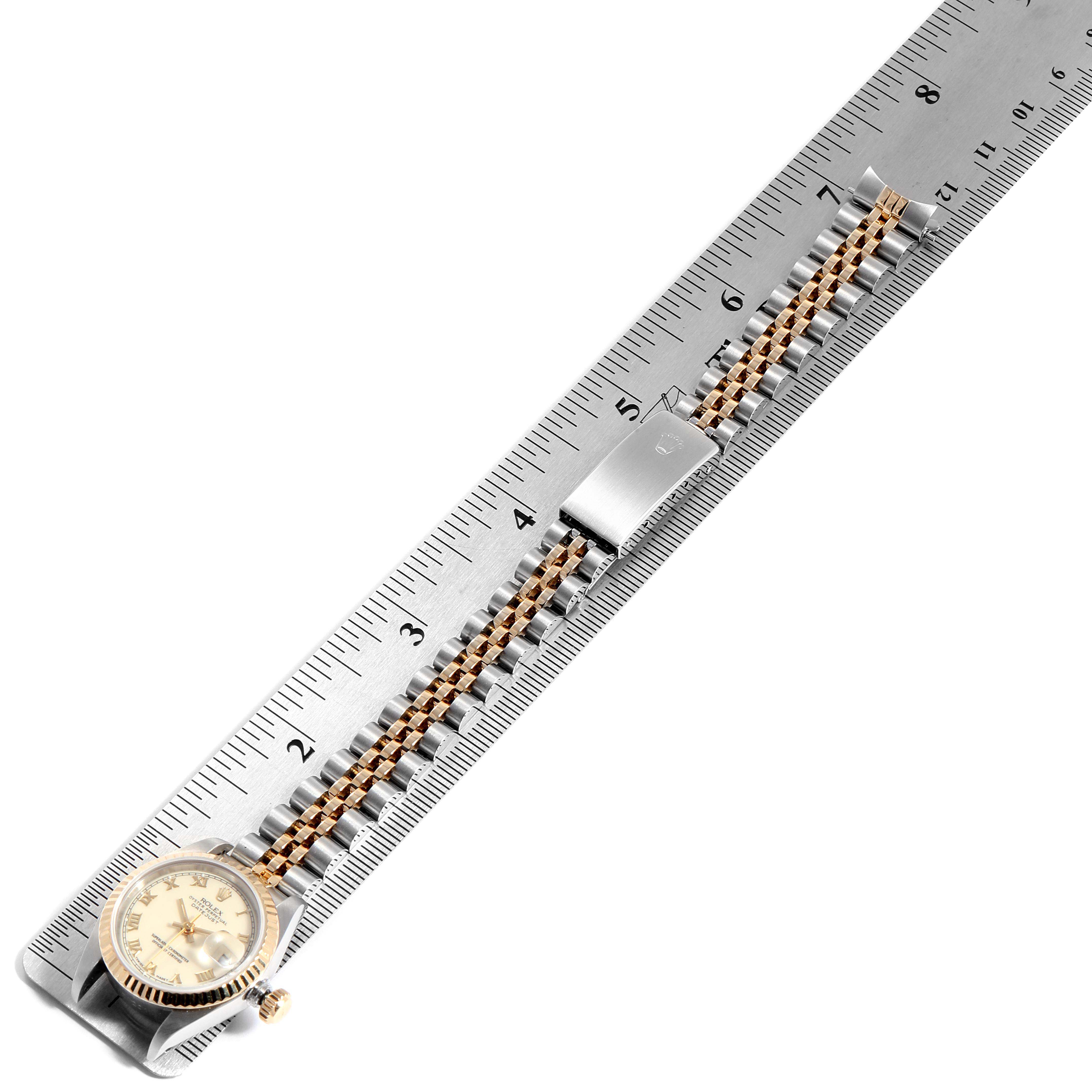 The image shows a top-down view of a Rolex Datejust 69173 Women
s Steel and Gold (two tone) Beige Dial 69173 Women
s Steel and Gold (two tone) Beige Dial watch placed next to a ruler for measurement.