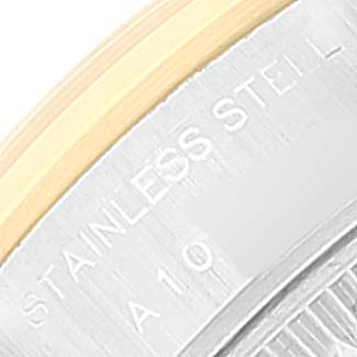 This close-up image shows the edge of the bezel and case of a Rolex Datejust 79163 Women
s Steel and Gold (two tone) Grey Dial 79163 Women
s Steel and Gold (two tone) Grey Dial watch, featuring the stainless steel inscription.