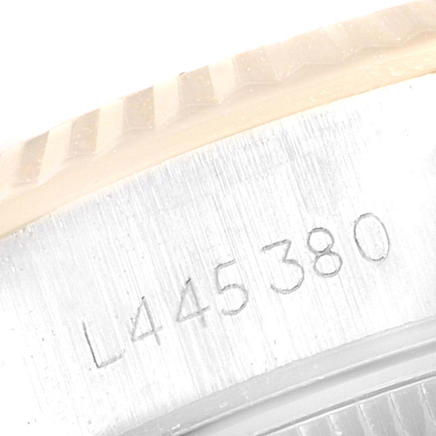 This image shows a close-up of the serial number engraved near the bezel on the Rolex Datejust 69173 Women's Steel and Gold (two tone) White Dial 69173 Women's Steel and Gold (two tone) White Dial watch.