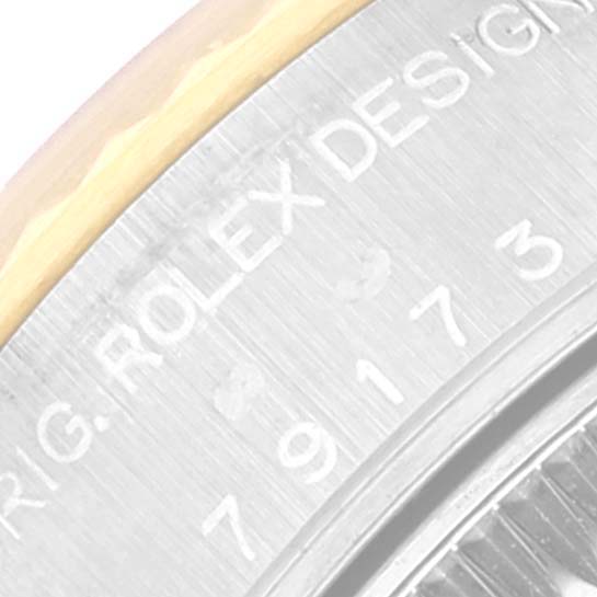 This image shows a close-up of the outer edge and engraved text on the bezel of a Rolex Datejust 79173 Women's Steel and Gold (two tone) White Dial 79173 Women's Steel and Gold (two tone) White Dial watch.