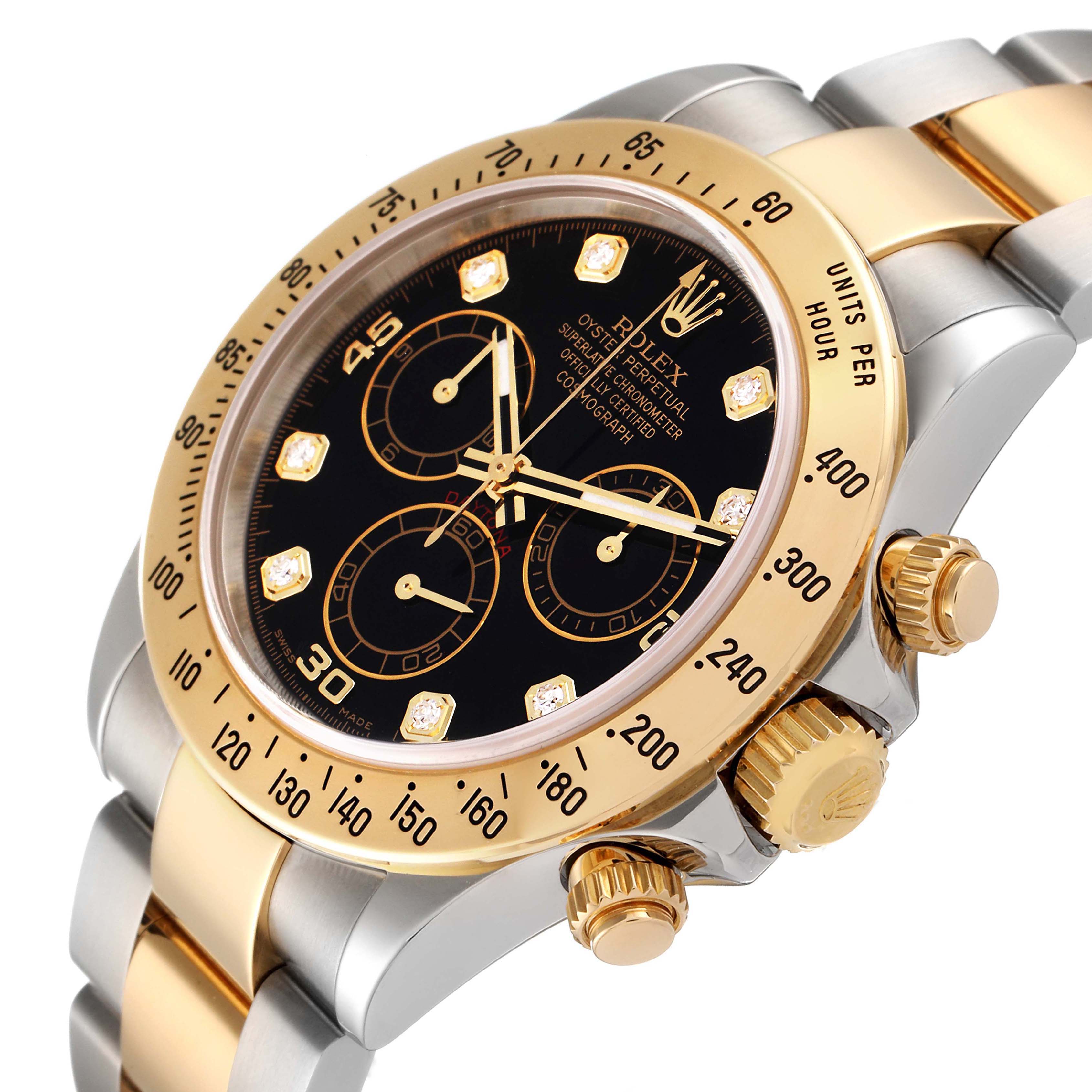 This image shows a close-up of the Rolex Daytona 116523 Men's Steel and Gold (two tone) Black Dial 116523 Men's Steel and Gold (two tone) Black Dial watch at an oblique angle, highlighting the bezel, dial, and crown.