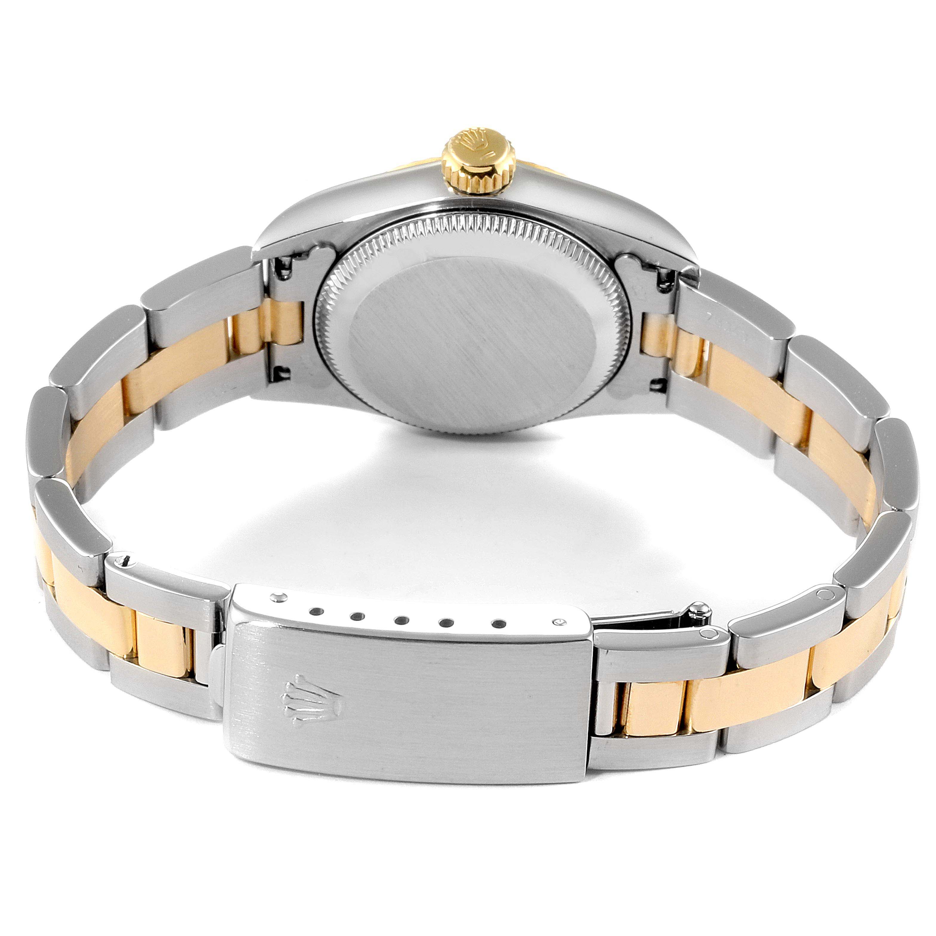 The image shows the back case and bracelet clasp of a Rolex Oyster Perpetual 67193 Women's Steel and Gold (two tone) Champagne Dial 67193 Women's Steel and Gold (two tone) Champagne Dial watch with a two-tone metal band.