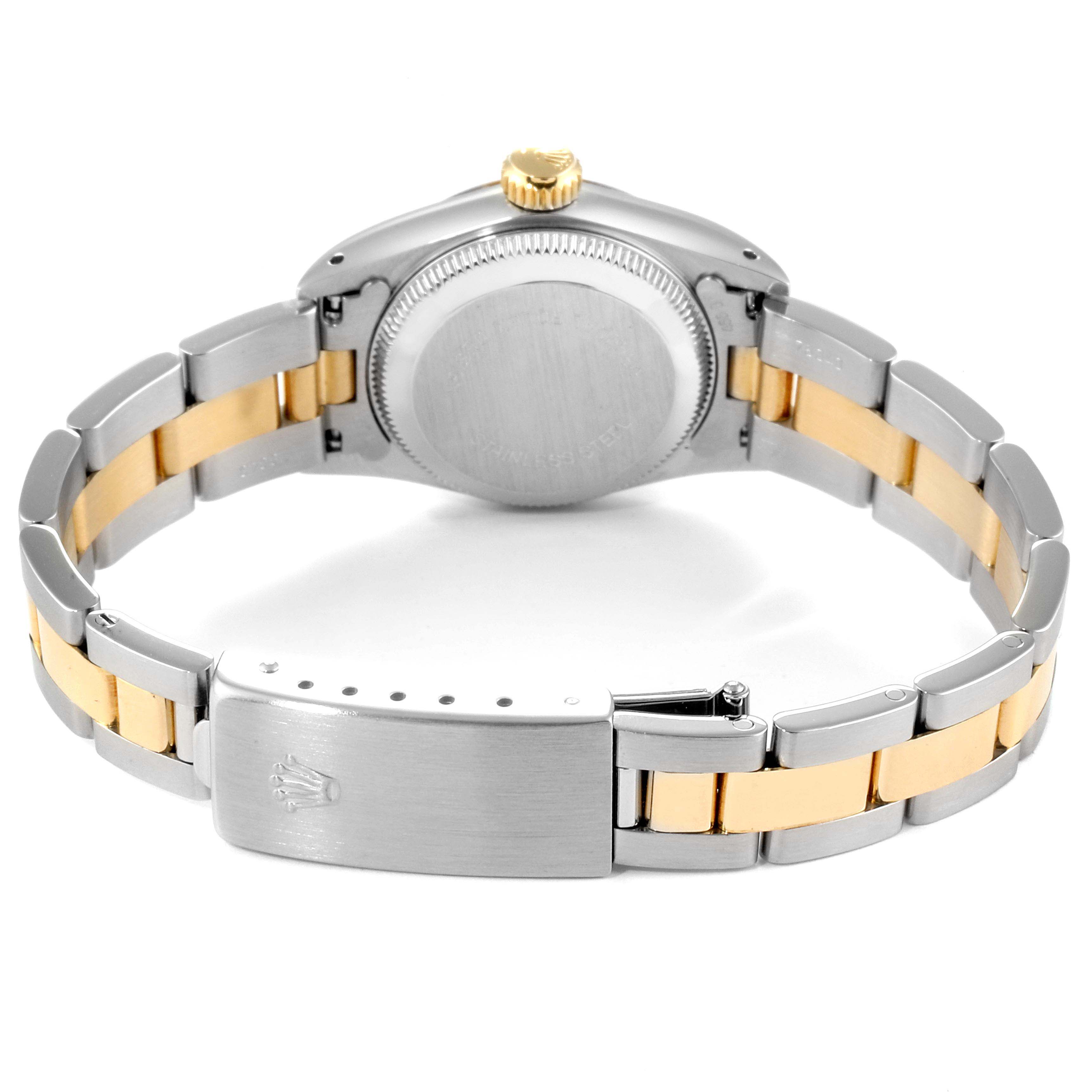 The image shows the back view of a Rolex Oyster Perpetual 67193 Women's Steel and Gold (two tone) Champagne Dial 67193 Women's Steel and Gold (two tone) Champagne Dial watch, highlighting the stainless steel and gold bracelet and the clasp.