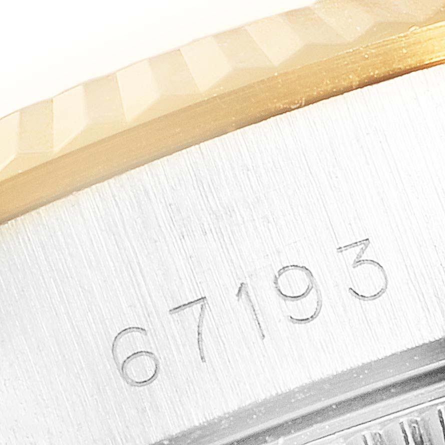 This close-up image of the Rolex Oyster Perpetual 67193 Women's Steel and Gold (two tone) Champagne Dial 67193 Women's Steel and Gold (two tone) Champagne Dial watch shows part of the bezel and the engraved model number "67193" on the case.