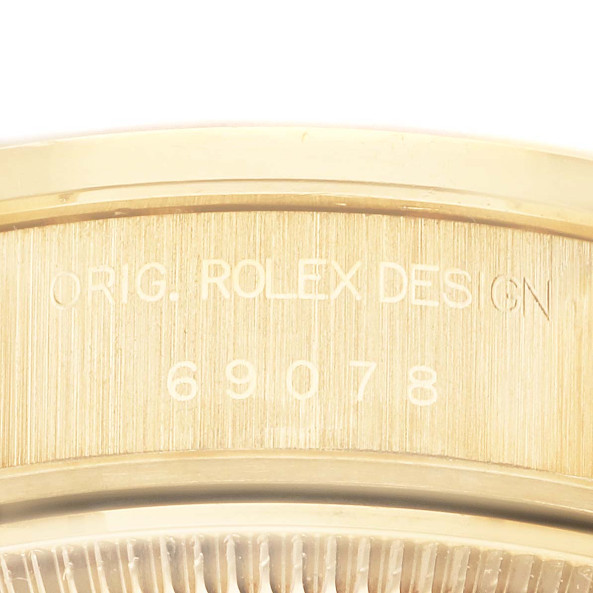 This image shows a close-up of the side of a Rolex President 69078 Women's Yellow Gold Champagne Dial 69078 Women's Yellow Gold Champagne Dial model watch, featuring its engraved design number.