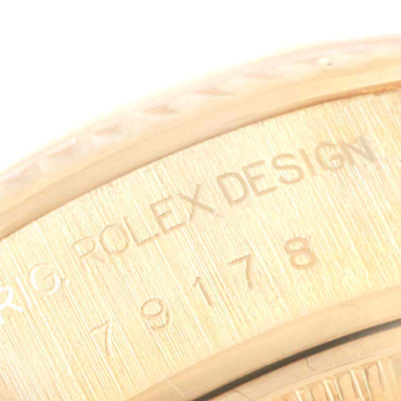 The image shows a close-up of the engraved bezel and caseback of a Rolex President 79178  Women
s Yellow Gold Champagne Dial 79178  Women
s Yellow Gold Champagne Dial model watch.