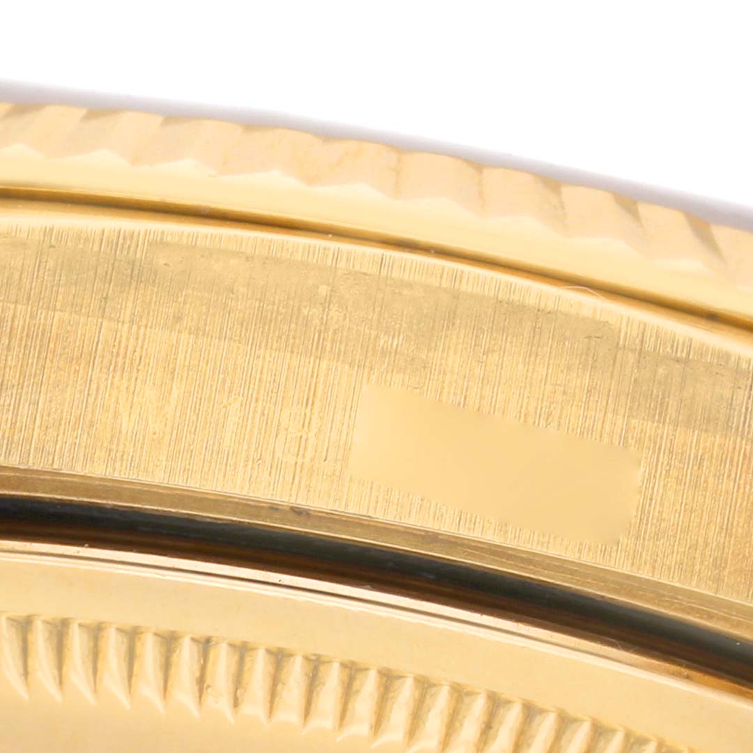 The image shows a close-up of the gold fluted bezel of a Rolex President 18238 Mens Yellow Gold Champagne Dial model watch.