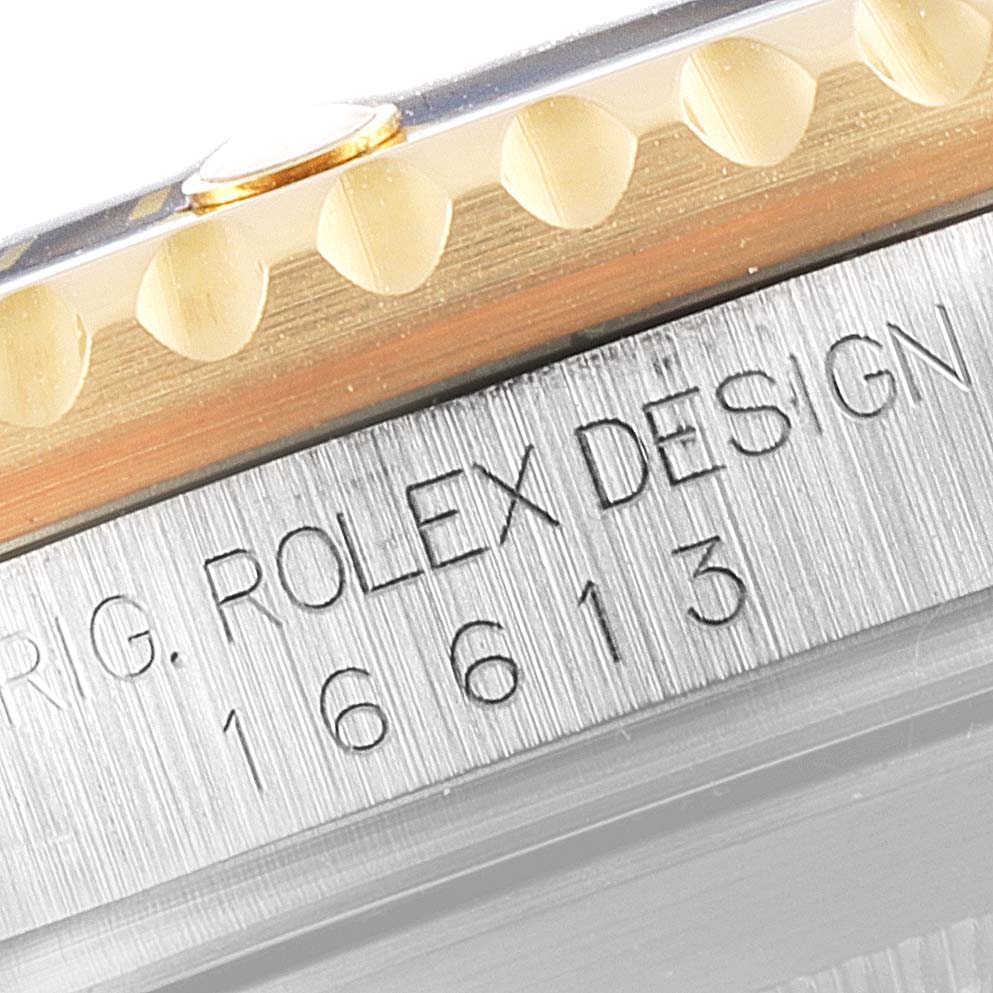 The image shows a close-up angle of the bezel and case edge with "16613" inscribed on a Rolex Submariner 16613 Men
s Steel and Gold (two tone) Blue Dial 16613 Men
s Steel and Gold (two tone) Blue Dial watch.