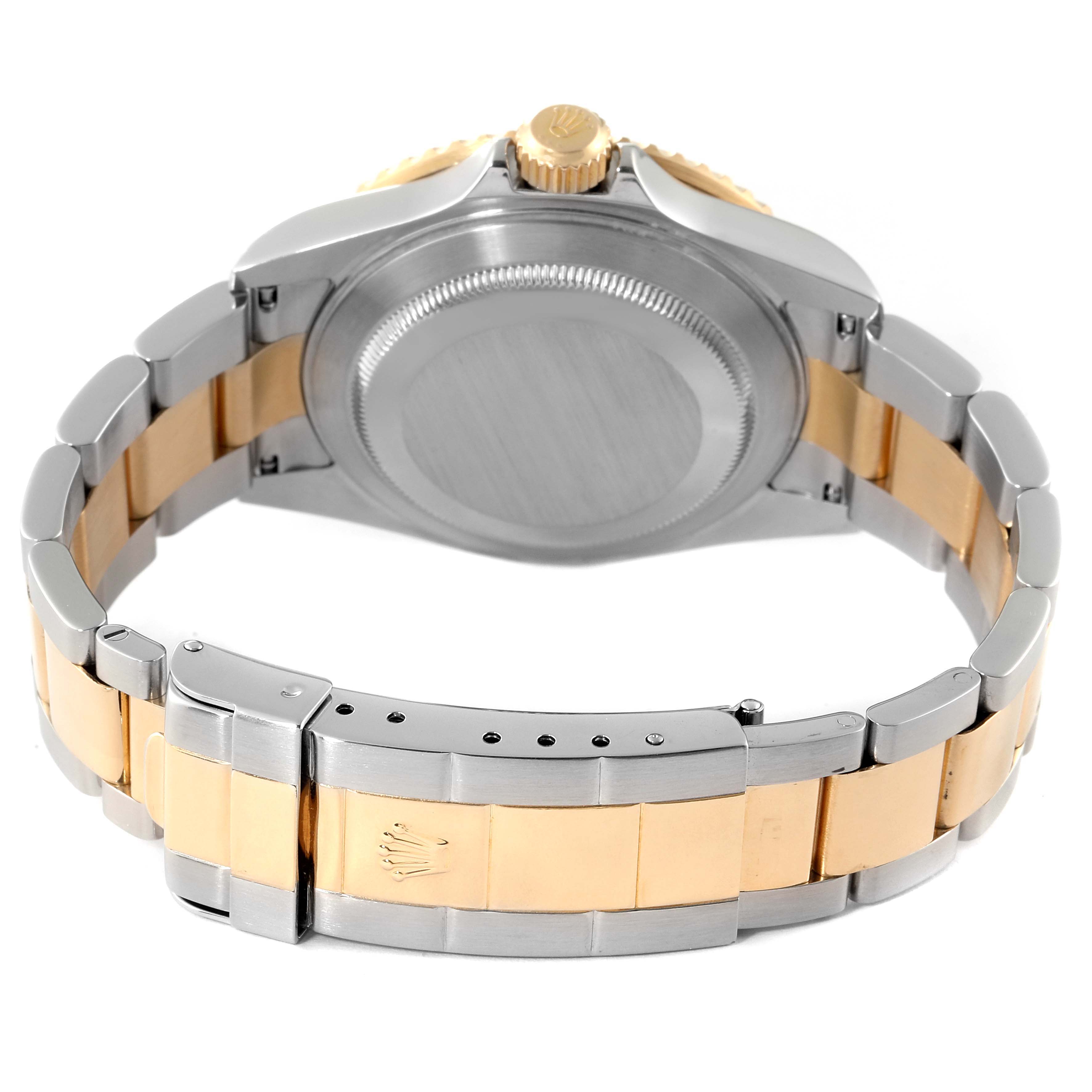 This image shows the back case and bracelet of a Rolex Submariner 16613 Men
s Steel and Gold (two tone) Blue Dial 16613 Men
s Steel and Gold (two tone) Blue Dial watch, highlighting its two-tone metal design and clasp.