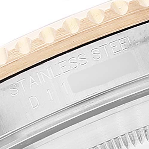 The image shows a close-up of the stainless steel case back and bezel edge of a Rolex Submariner 16613 Men
s Steel and Gold (two tone) Blue Dial 16613 Men
s Steel and Gold (two tone) Blue Dial watch.