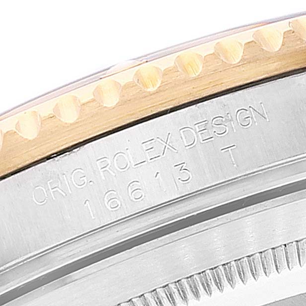 This image shows a close-up of the case side and engraved marking of a Rolex Submariner 16613 Men
s Steel and Gold (two tone) Blue Dial 16613 Men
s Steel and Gold (two tone) Blue Dial model.