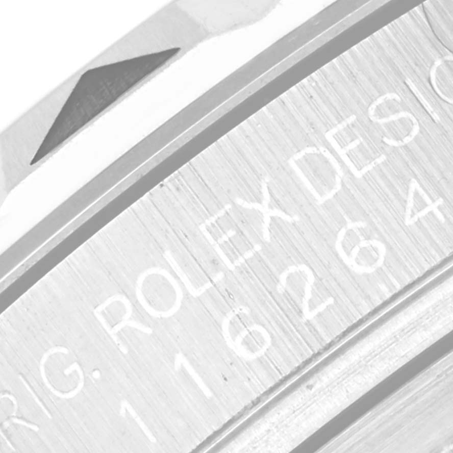 This close-up image shows part of the bezel and engraved text on the side of the case of a Rolex Turn-o-Graph 116264 Men
s Stainless Steel White Dial 116264 Men
s Stainless Steel White Dial watch.