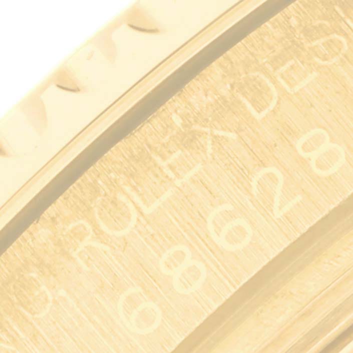 Close-up of the Rolex Yacht-Master 68628 Men's Yellow Gold White Dial 68628 Men's Yellow Gold White Dial model, showing a detailed side view of the bezel and engraved markings.