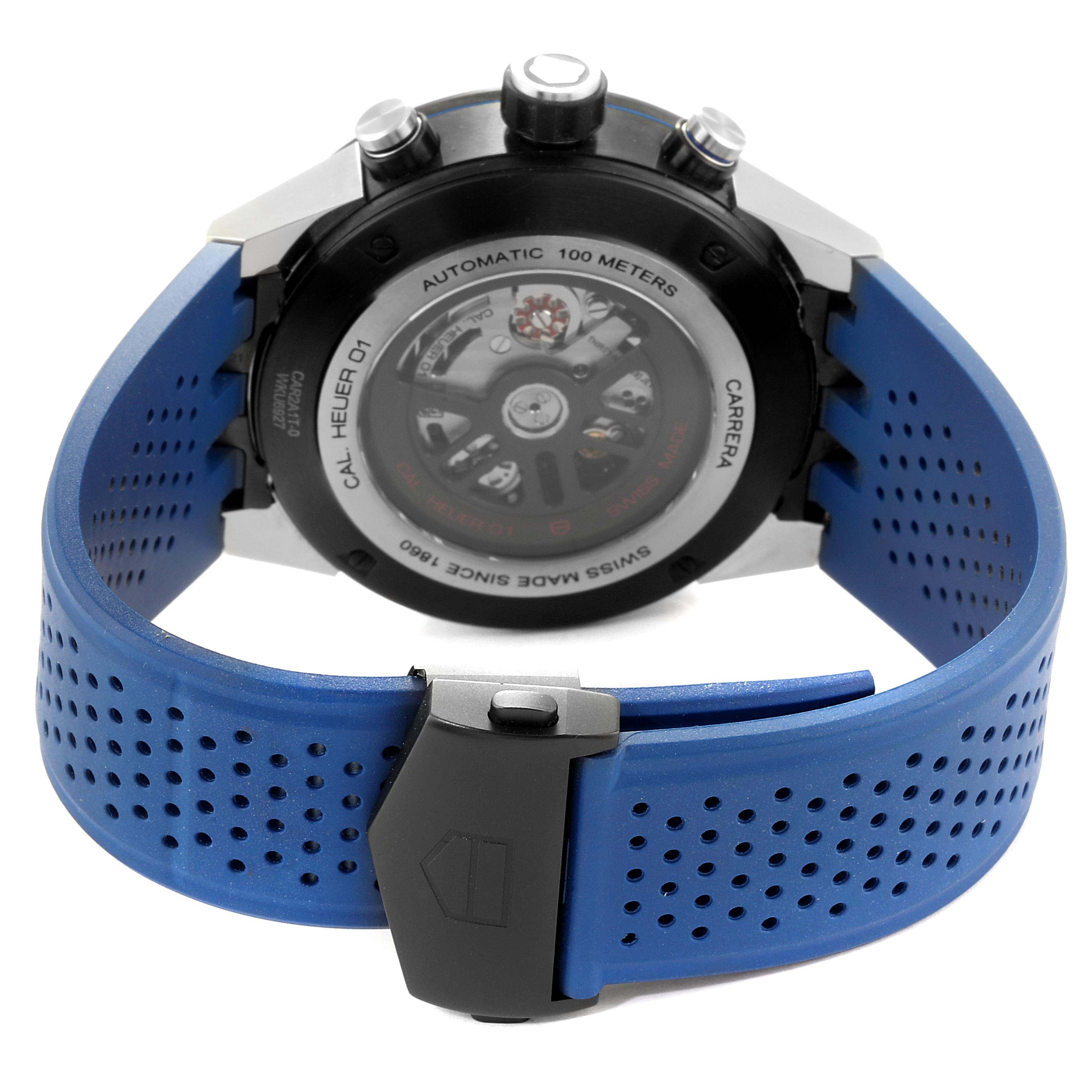 The image shows the back of a Tag Heuer Carrera CAR2A1T.FT6052 Men's Titanium Black Dial CAR2A1T.FT6052 Men's Titanium Black Dial watch, displaying its movement and blue perforated strap.