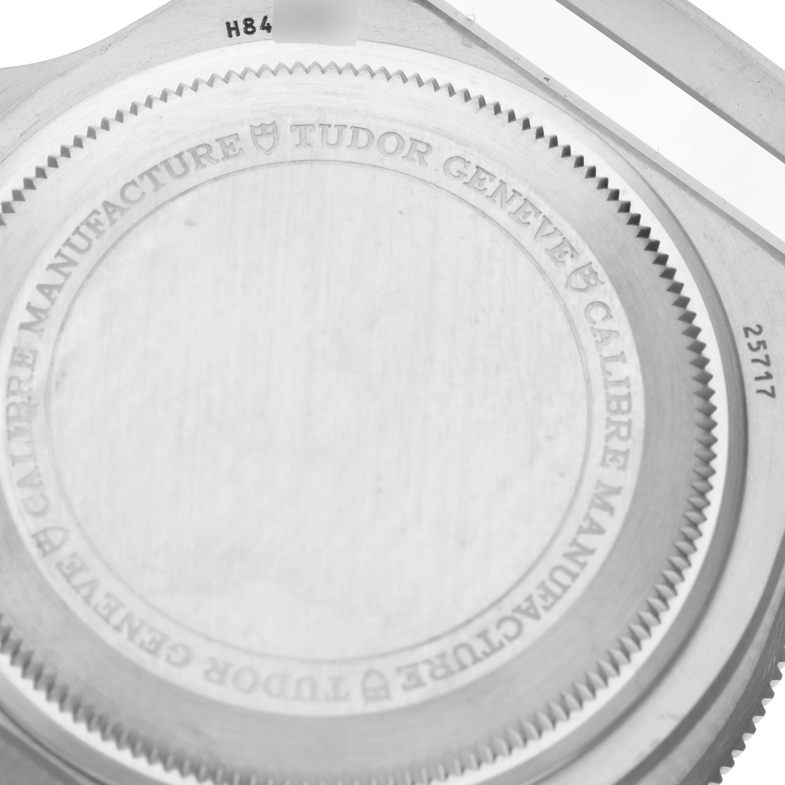 The image shows the back case of a Tudor Pelagos M25717N-0001 Men
s Titanium Black Dial M25717N-0001 Men
s Titanium Black Dial watch, featuring engraved text detailing the brand and model.