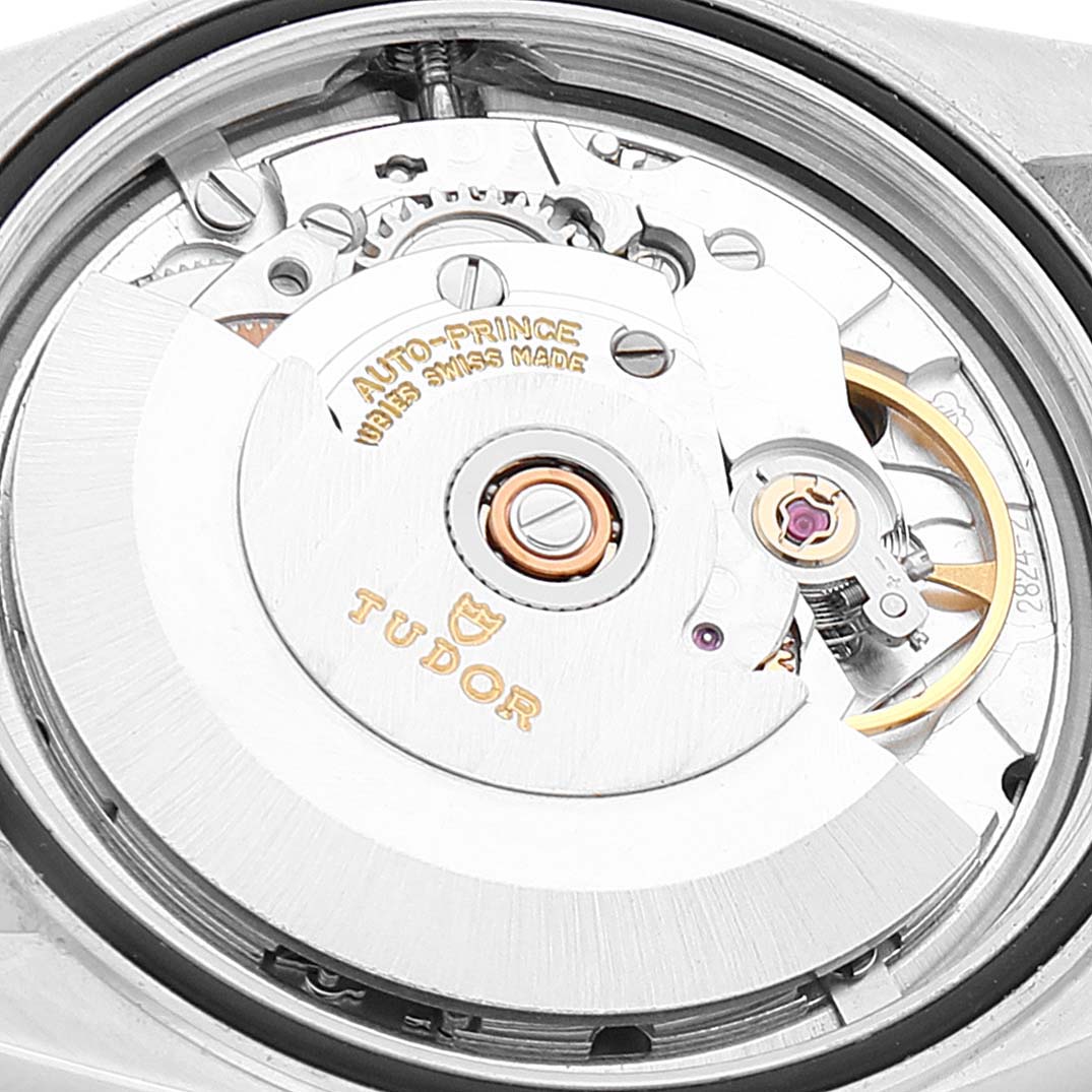 This image shows a close-up of the movement and rotor of the Tudor Prince 74000N Men
s Stainless Steel Silver Dial 74000N Men
s Stainless Steel Silver Dial model watch, displaying intricate gears and the brand logo.