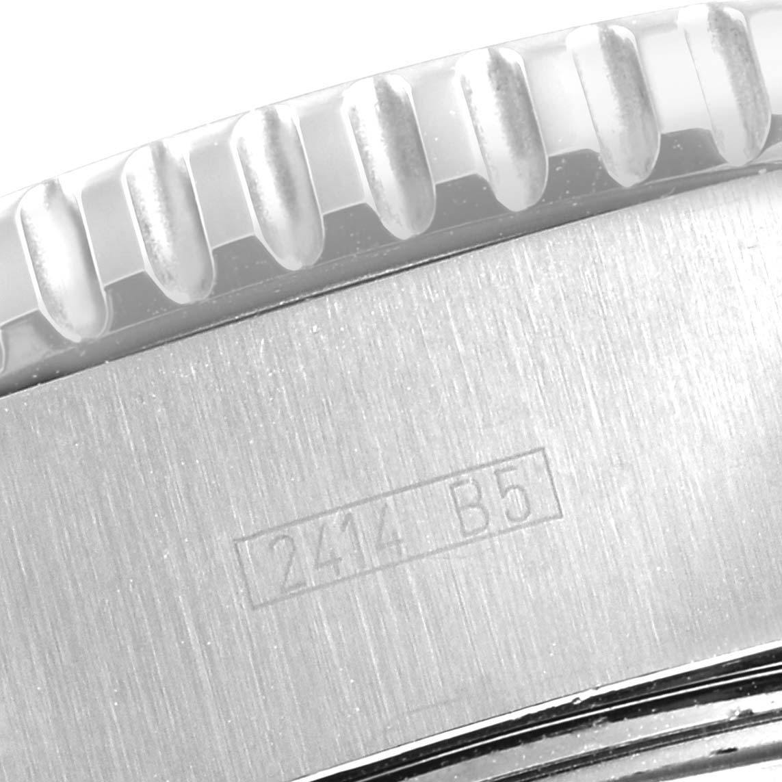 The image shows a close-up of the edge of the bezel and part of the case side with an engraving from a Breitling Superocean A13341C3/BD19 Men's Stainless Steel White Dial A13341C3/BD19 Men's Stainless Steel White Dial watch.