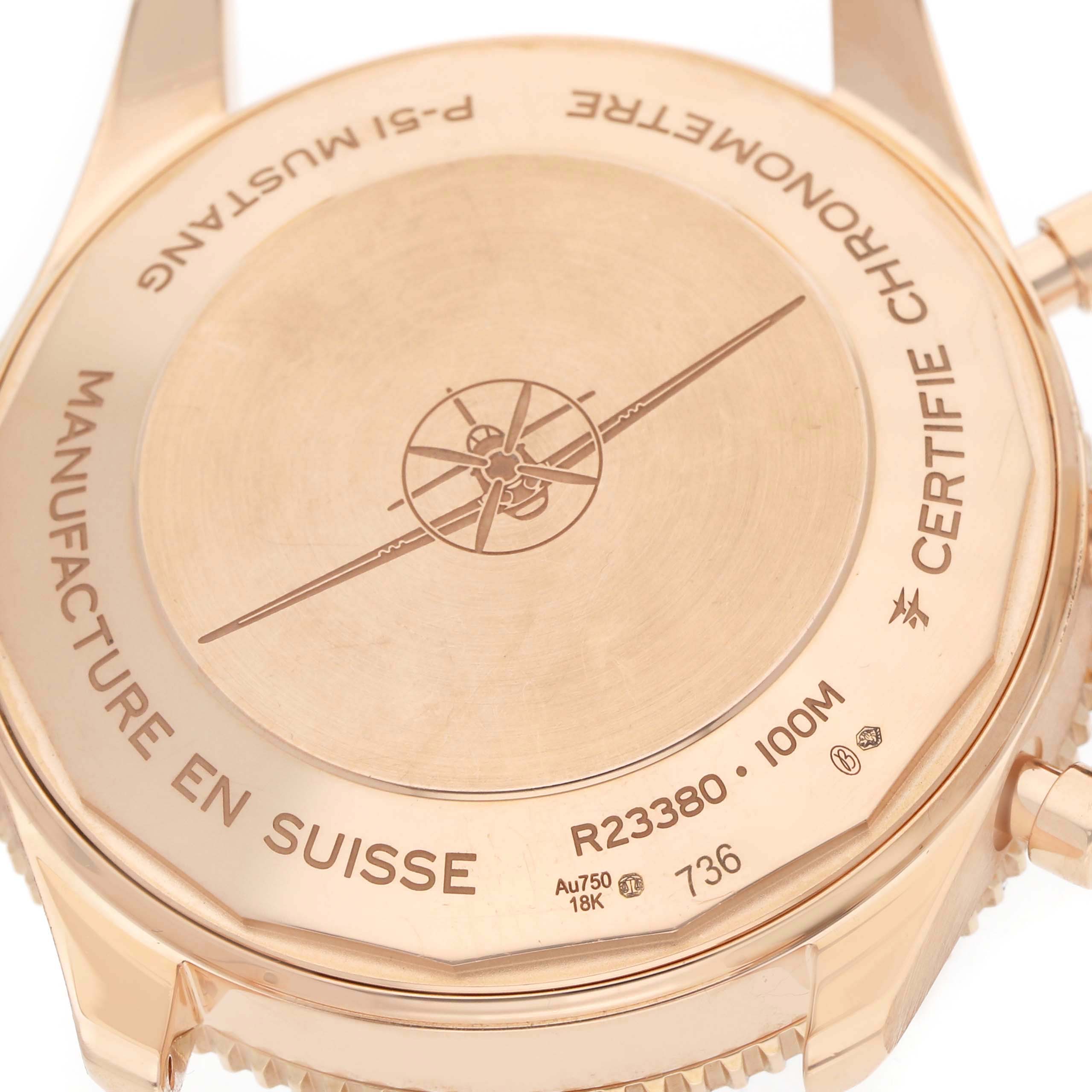 The image shows the case back of a Breitling Aviator R23380 Men's Rose Gold Grey Dial watch, featuring inscriptions and a propeller design.