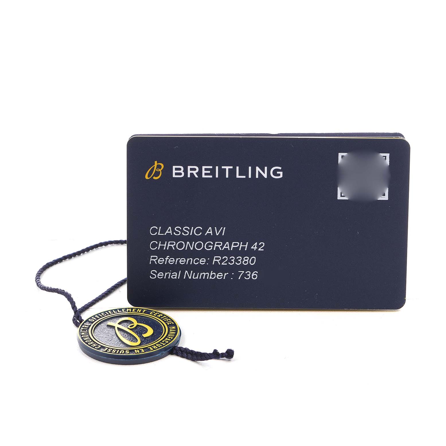 The image shows a Breitling Aviator R23380 Men's Rose Gold Grey Dial model warranty card and a hang tag with logo, viewed from above.