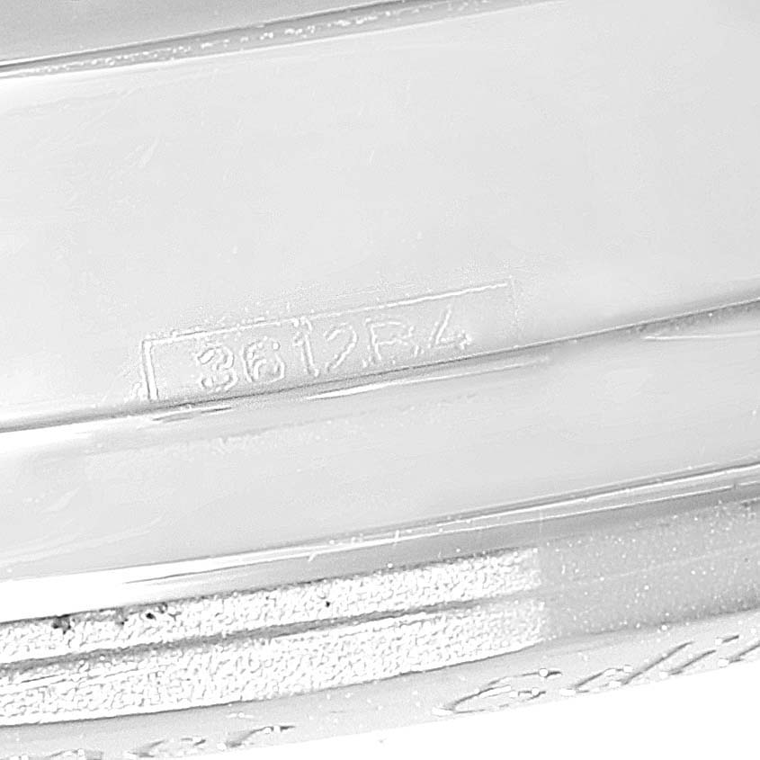 The image shows a close-up of the engraved serial number on the metal part of a Breitling Navitimer AB0123 Men's Stainless Steel Silver Dial AB0123 Men's Stainless Steel Silver Dial watch.