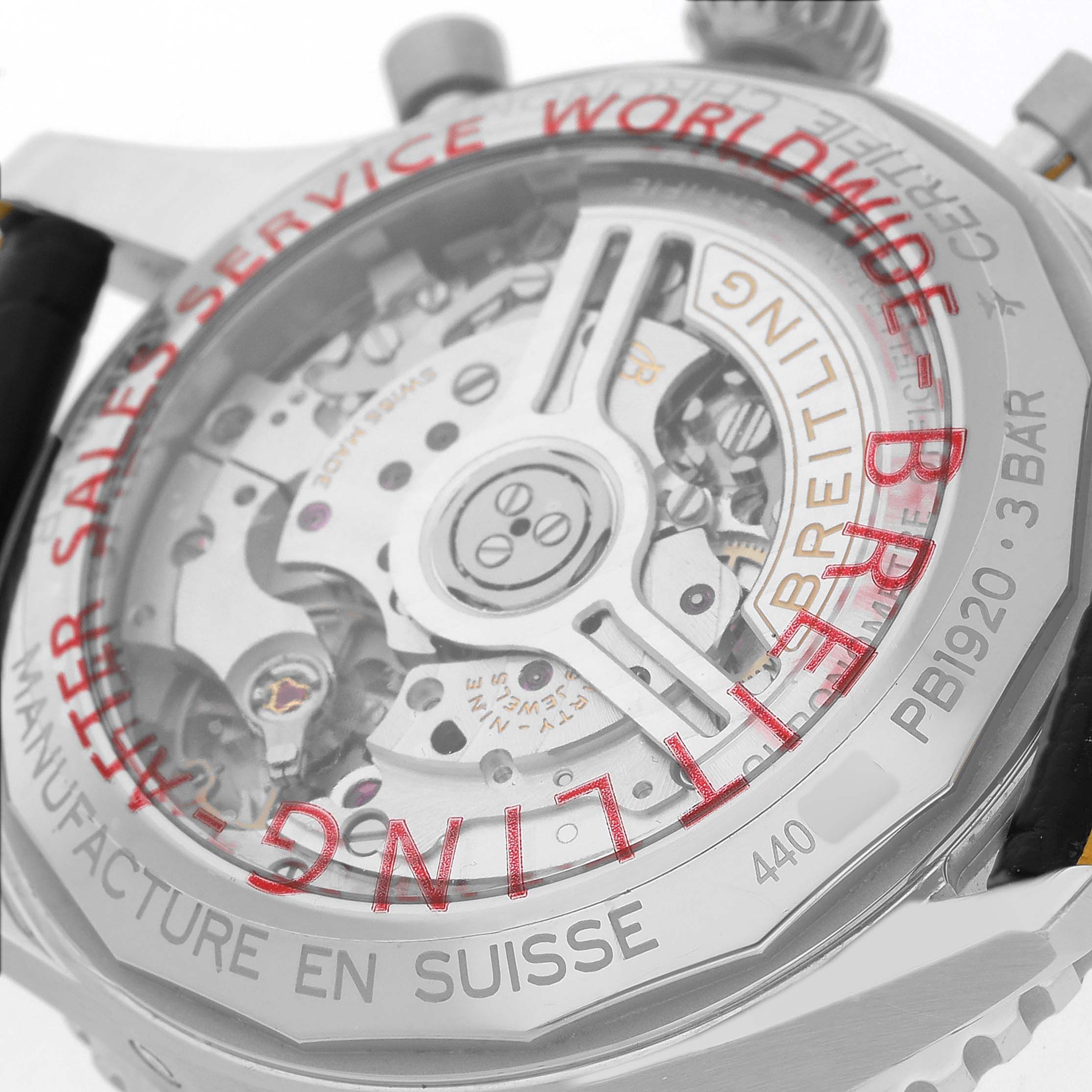 The image shows the back of the Breitling Navitimer PB1920 Men's Stainless Steel Blue Dial watch, highlighting its intricate mechanical movement.