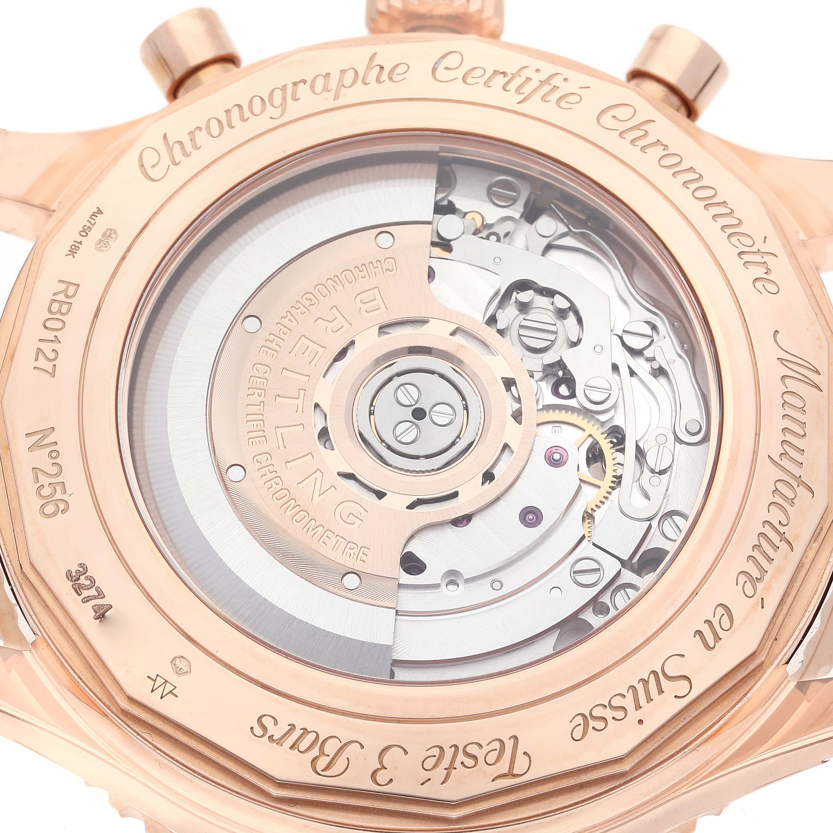 The image shows the back case of a Breitling Navitimer RB0127 Men's Rose Gold Silver Dial RB0127 Men's Rose Gold Silver Dial watch, highlighting its intricate mechanical movement and engravings.