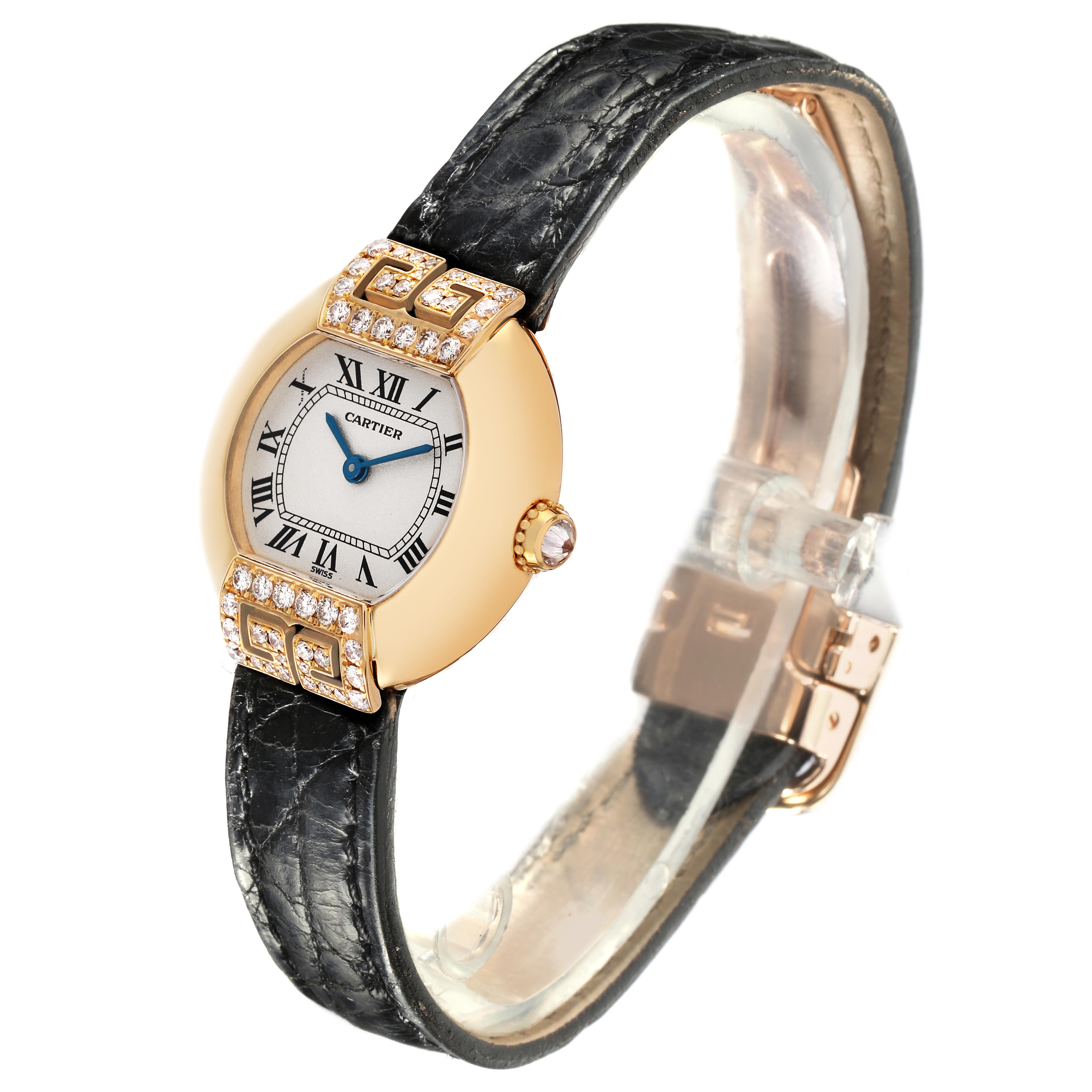 The Cartier Tortue WB600851 Women
s Yellow Gold Silver Dial WB600851 Women
s Yellow Gold Silver Dial watch is shown at a three-quarter angle, highlighting its diamond-studded bezel, dial, and leather strap.