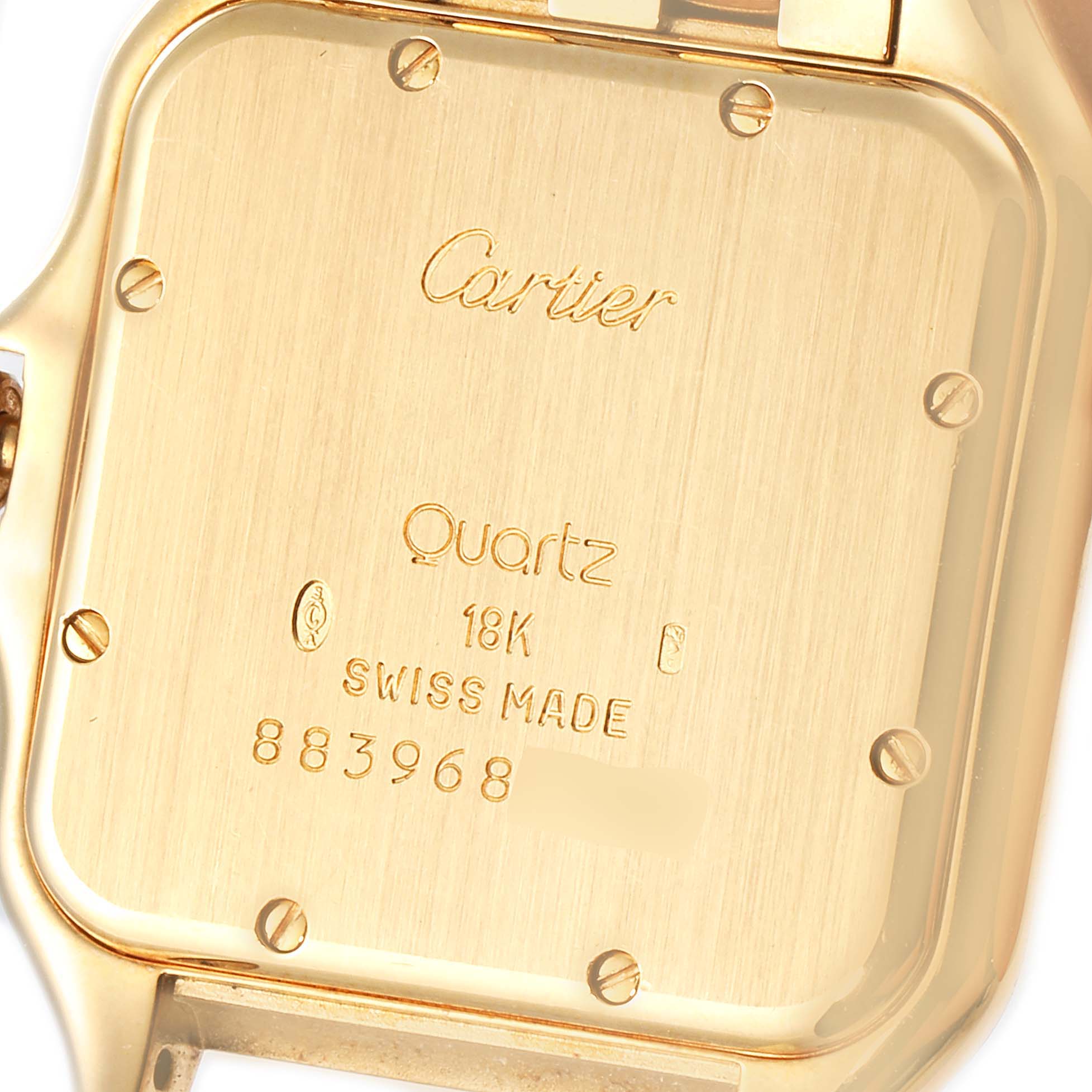 The image shows the back of a Cartier Panthere W25014B9 Men's Yellow Gold Silver Dial W25014B9 Men's Yellow Gold Silver Dial model watch, displaying its engravings and screws.