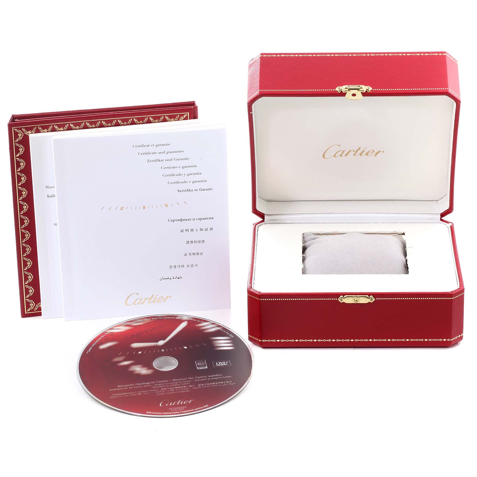 The image shows the accessories for a Cartier Ronde W6701005 Men
s Stainless Steel Silver Dial W6701005 Men
s Stainless Steel Silver Dial watch, including its red box, warranty booklet, and a CD.
