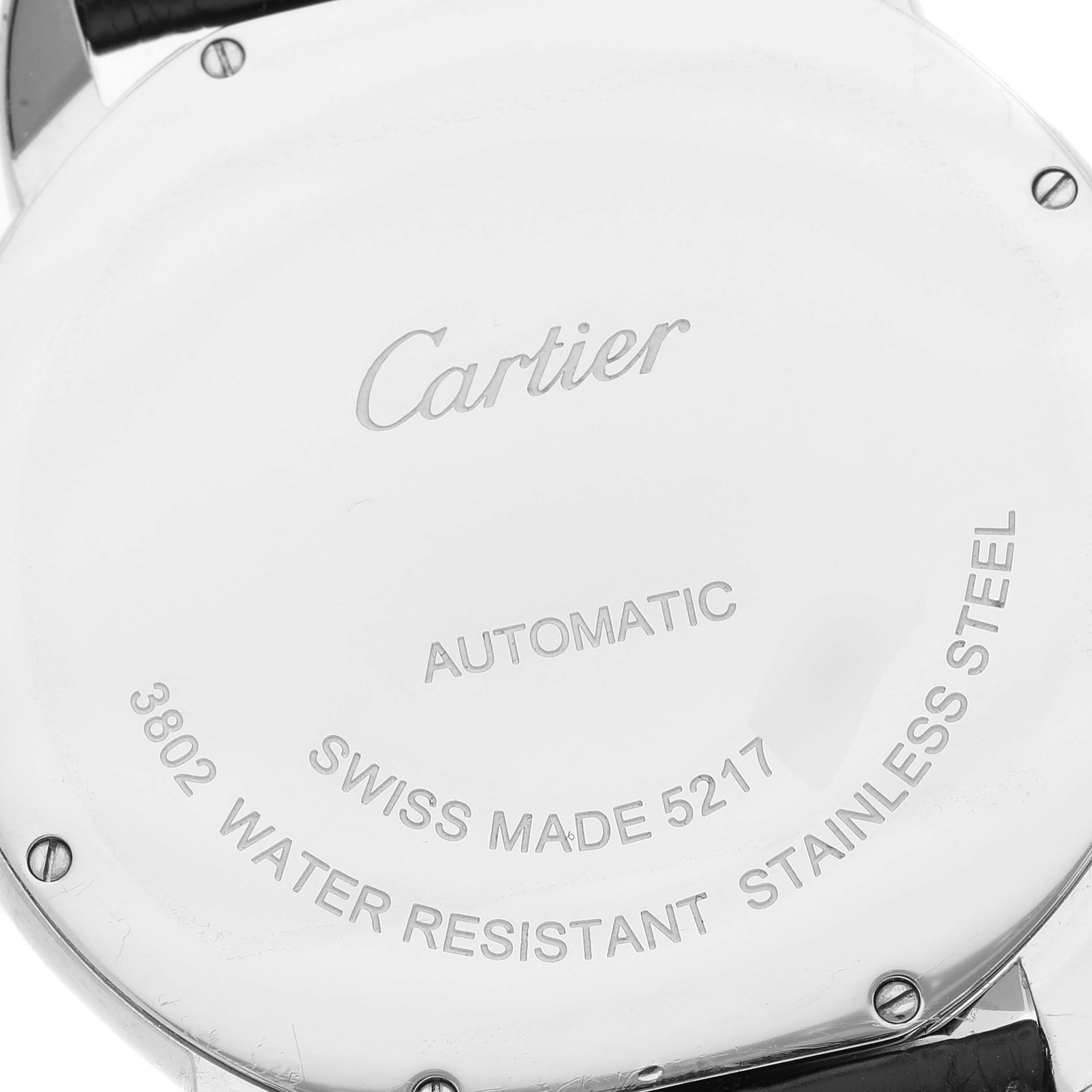 The image shows the back casing of a Cartier Ronde W6701011 Men
s Stainless Steel Silver Dial W6701011 Men
s Stainless Steel Silver Dial watch, highlighting inscriptions and screws.