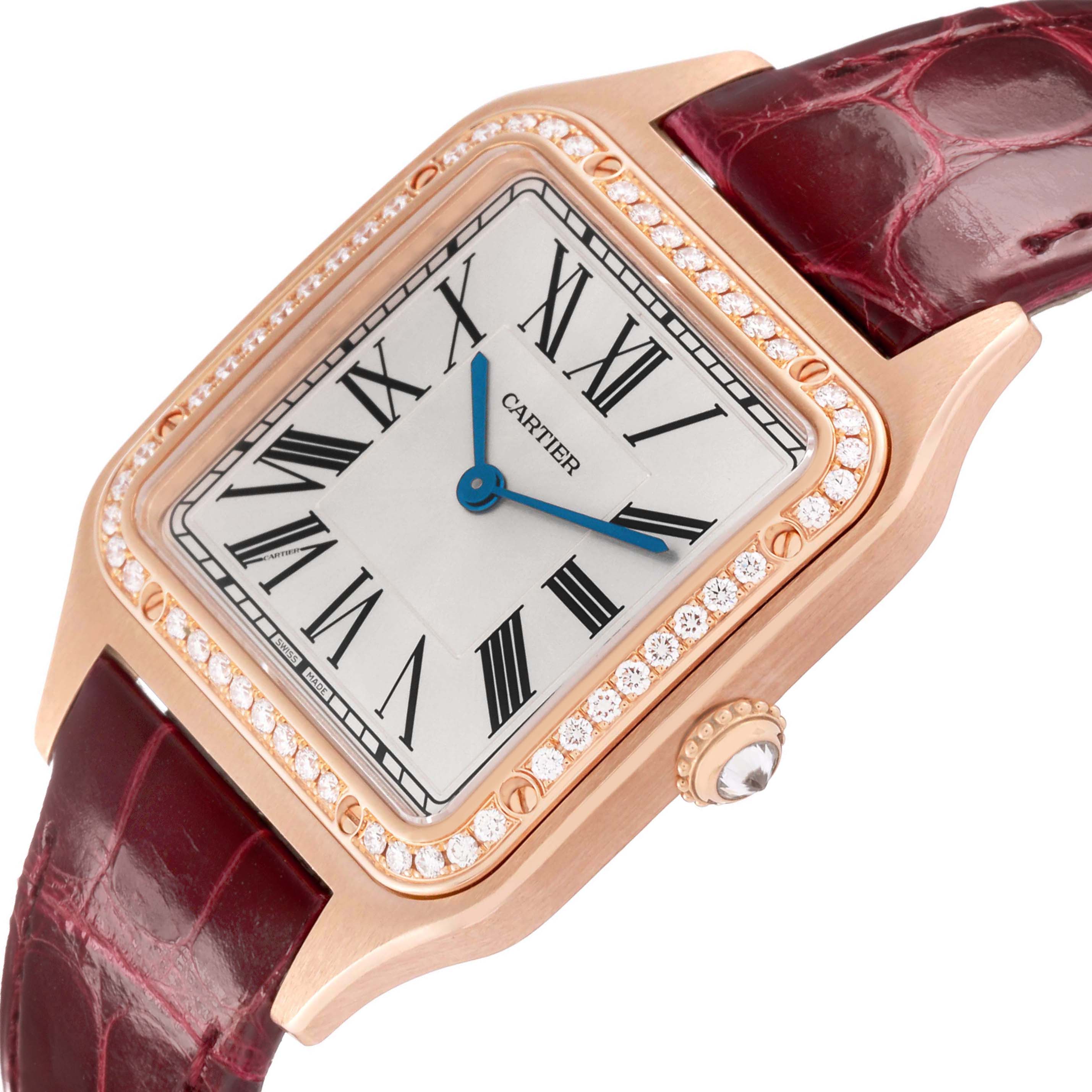 The Cartier Santos WJSA0016 Women's Rose Gold Silver Dial watch is shown at an angled close-up, highlighting its face, diamond bezel, and leather strap.