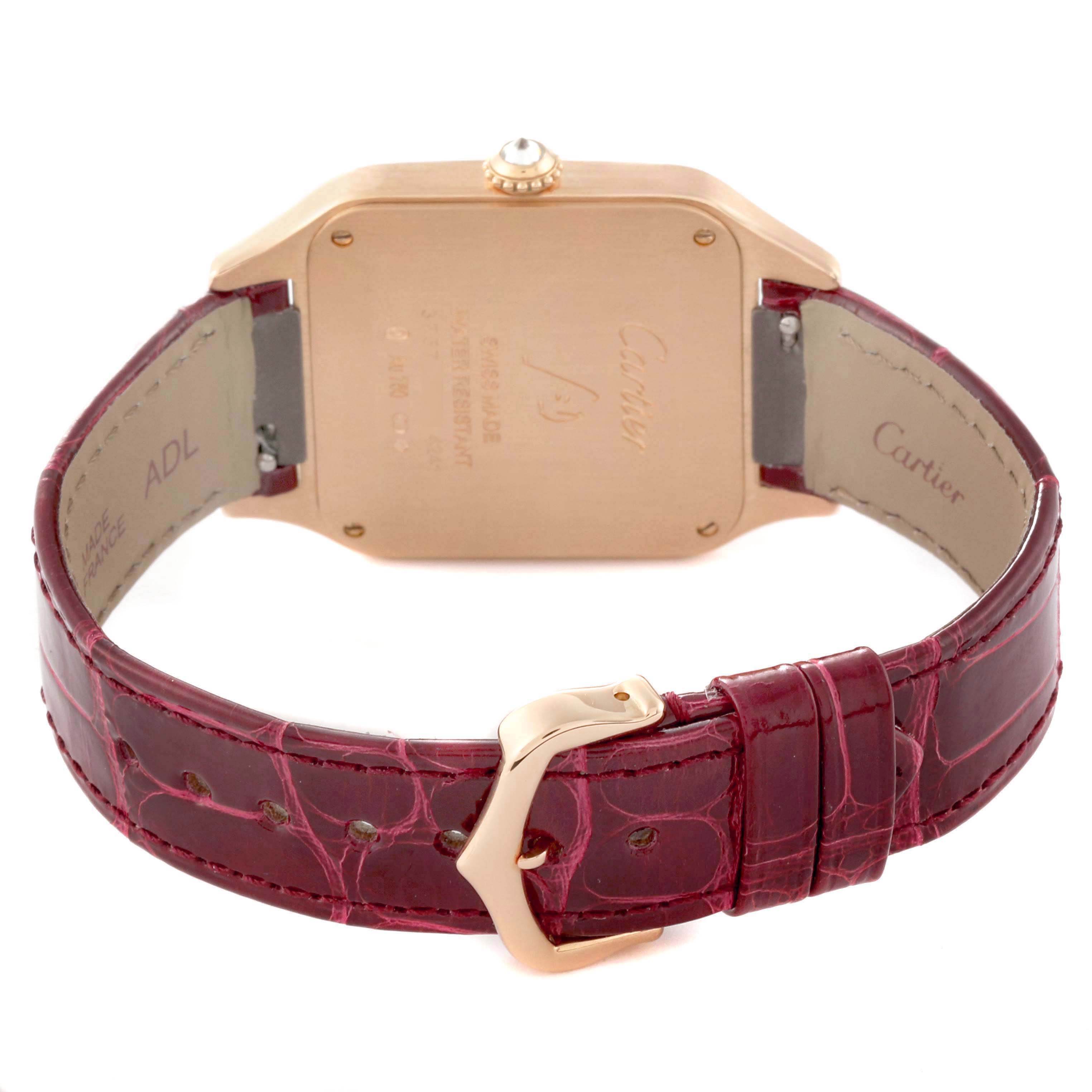The image shows the back of a Santos model by Cartier, highlighting the watch case, crown, and burgundy leather strap with a buckle.