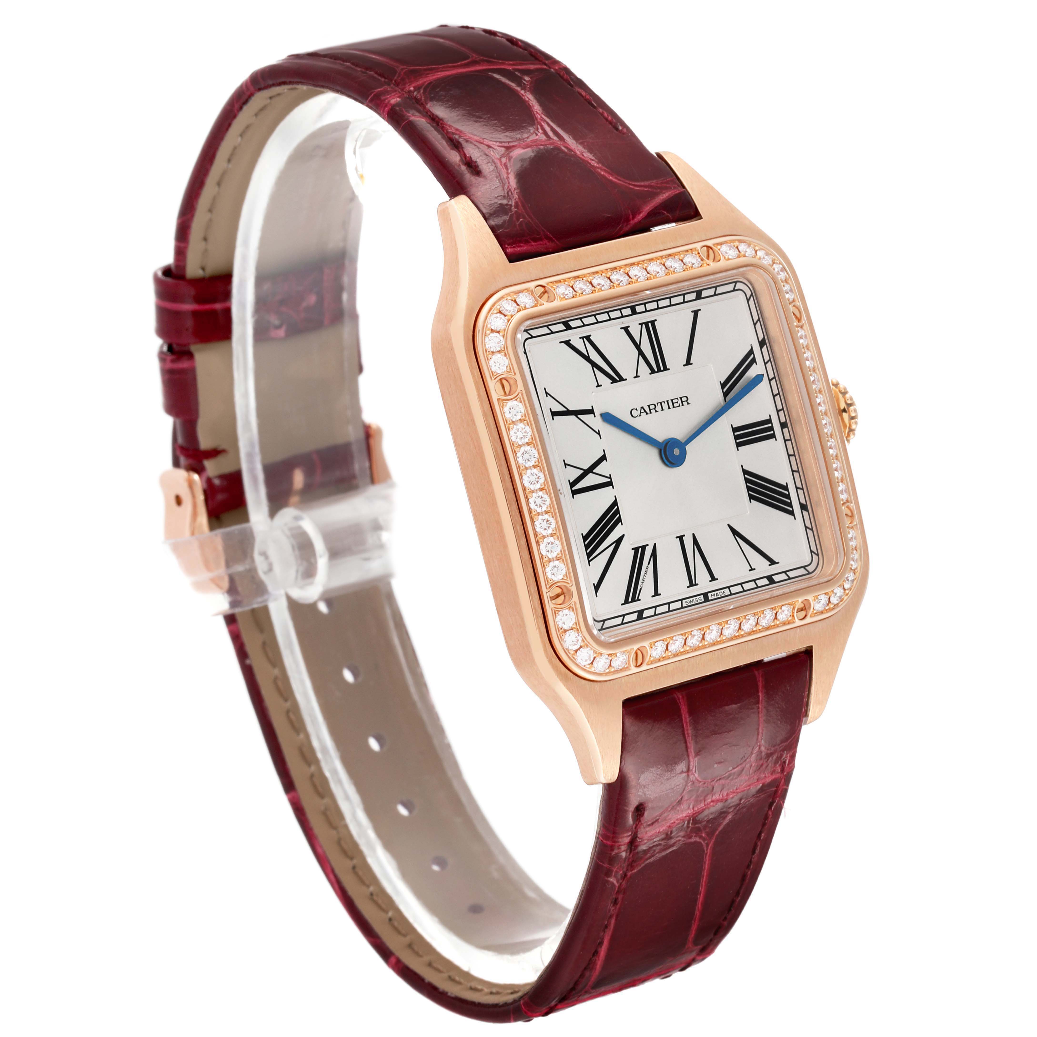 The Cartier Santos WJSA0016 Women's Rose Gold Silver Dial watch is shown at a three-quarter angle, displaying its dial, case, diamond bezel, and leather strap.