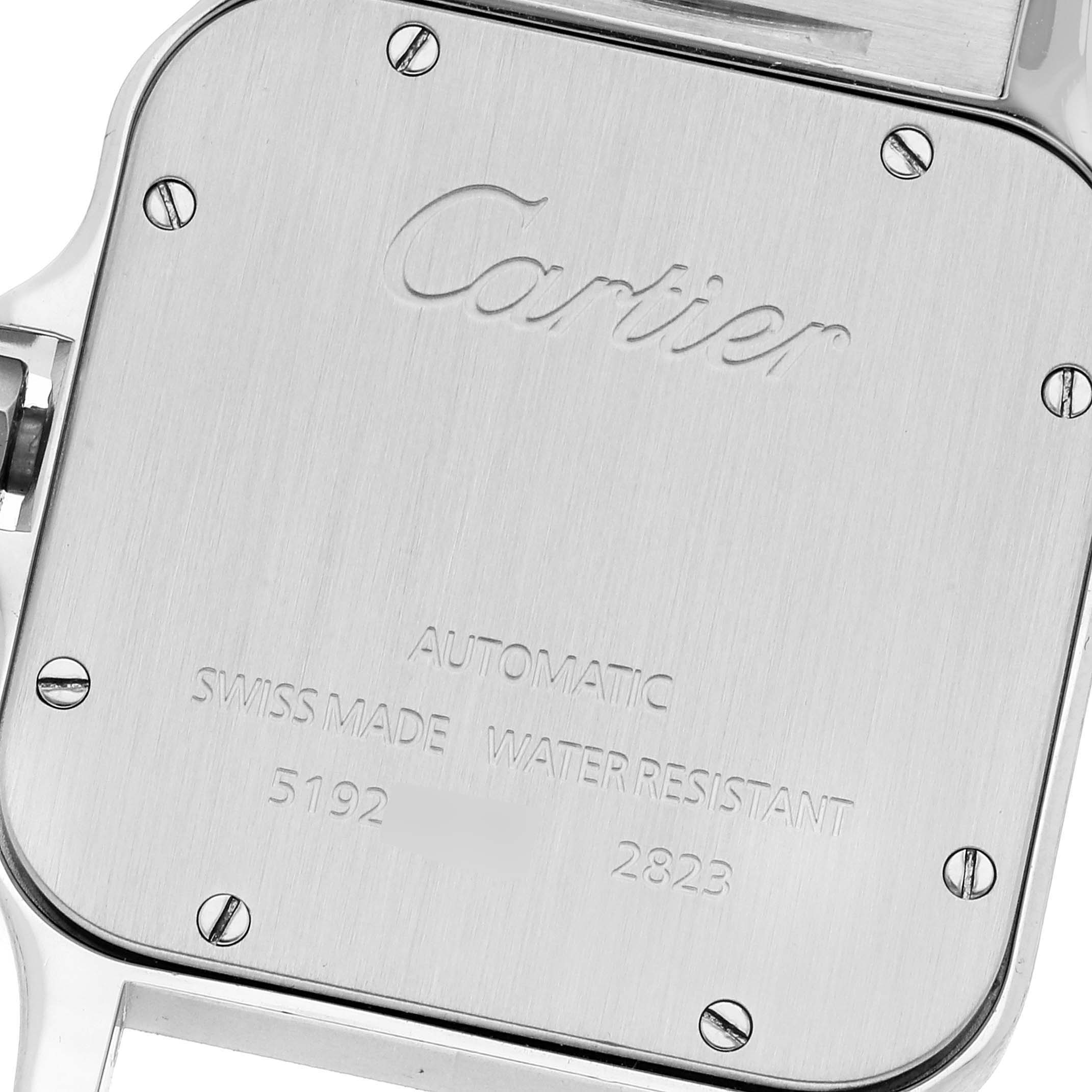 The image shows the back case of a Santos model by Cartier, featuring inscriptions and screws.