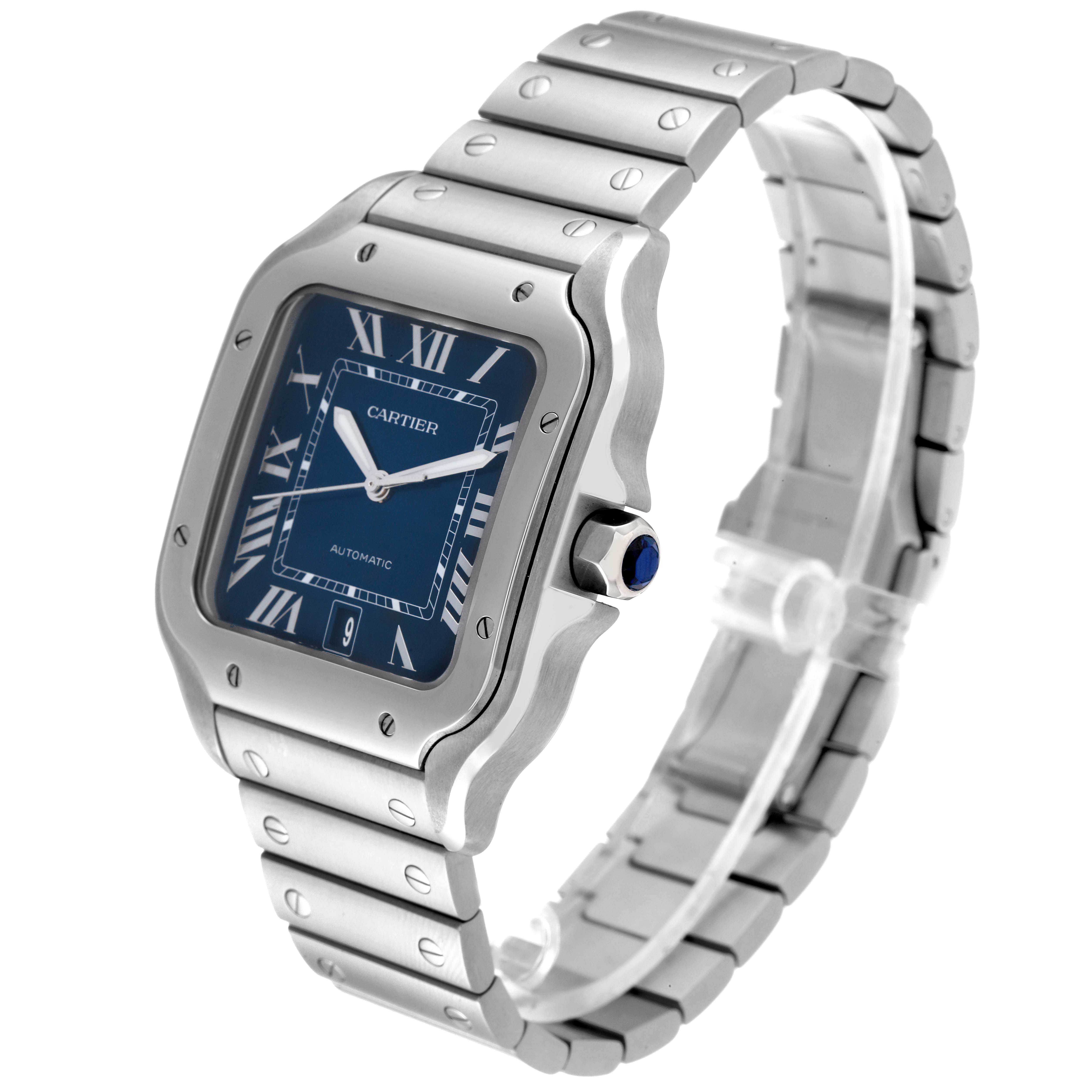 The image shows a Cartier Santos WSSA0030 Men's Stainless Steel Blue Dial WSSA0030 Men's Stainless Steel Blue Dial watch at a front angle, displaying its square face, metal bracelet, and crown with a blue gemstone.