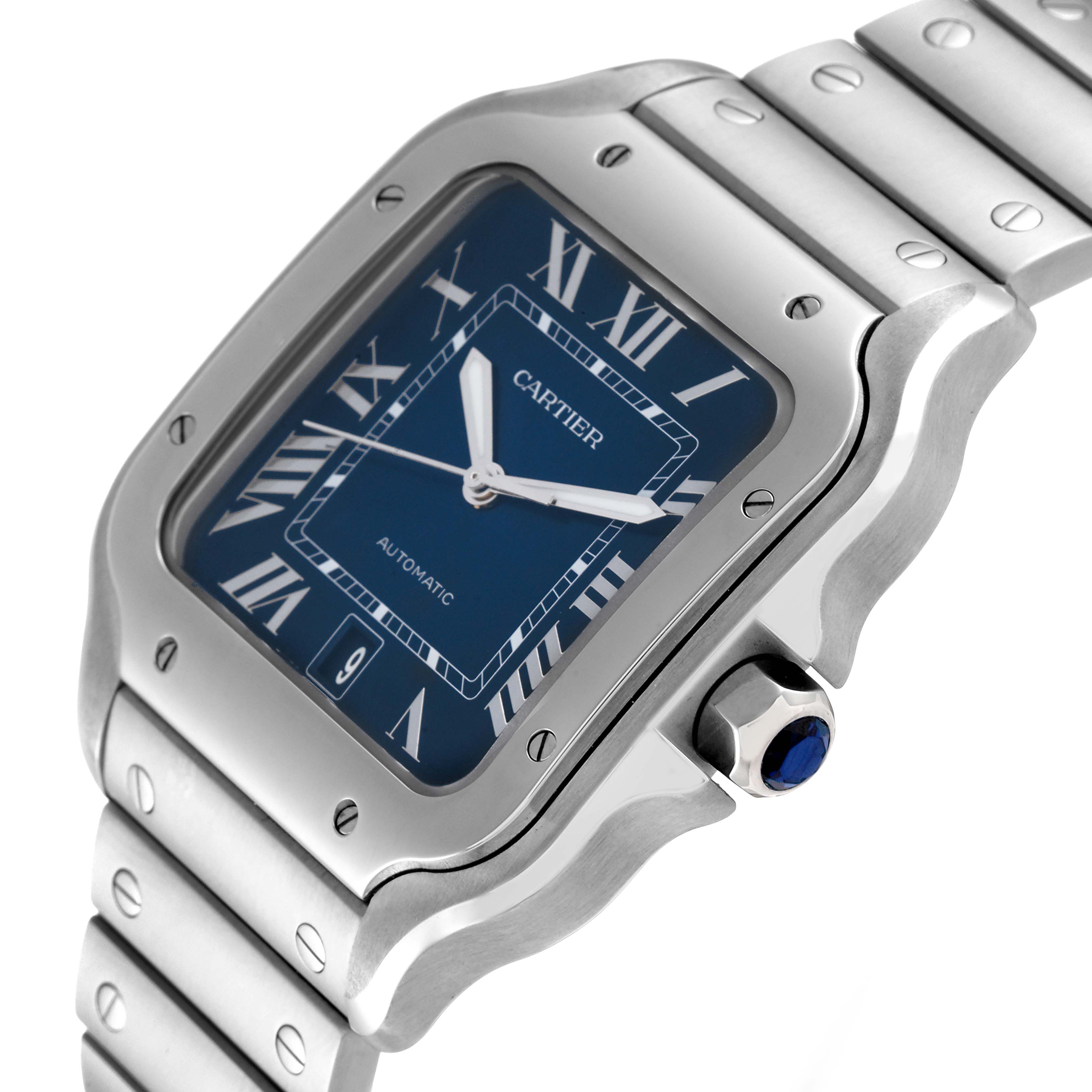 The image displays a Cartier Santos WSSA0030 Men's Stainless Steel Blue Dial WSSA0030 Men's Stainless Steel Blue Dial watch at an oblique angle showing its face, bezel, crown, and part of the bracelet.