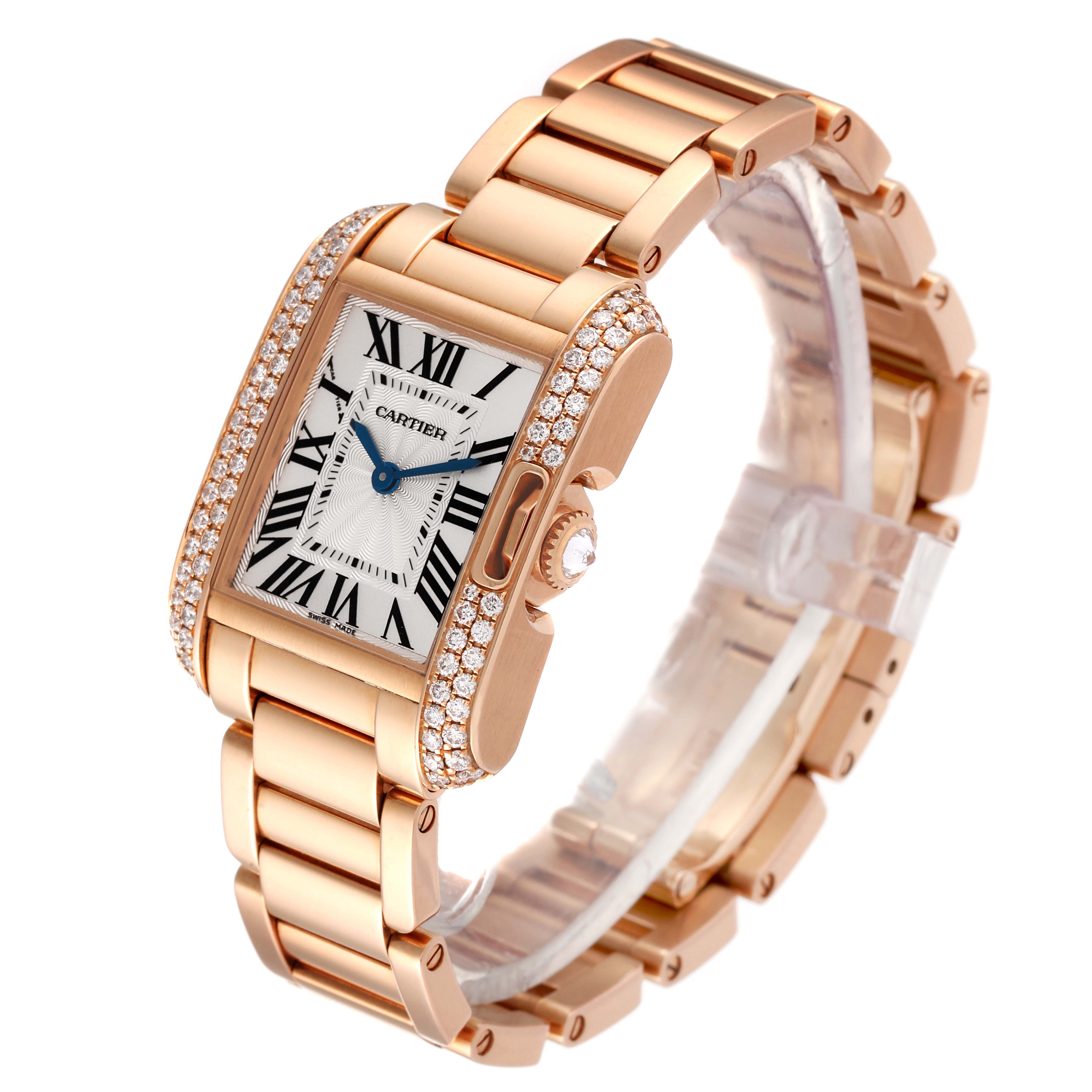 The Cartier Tank Anglaise WT100002 Women
s Rose Gold Silver Dial WT100002 Women
s Rose Gold Silver Dial watch is shown at an angle highlighting its gold case, diamond bezel, and Roman numeral dial.
