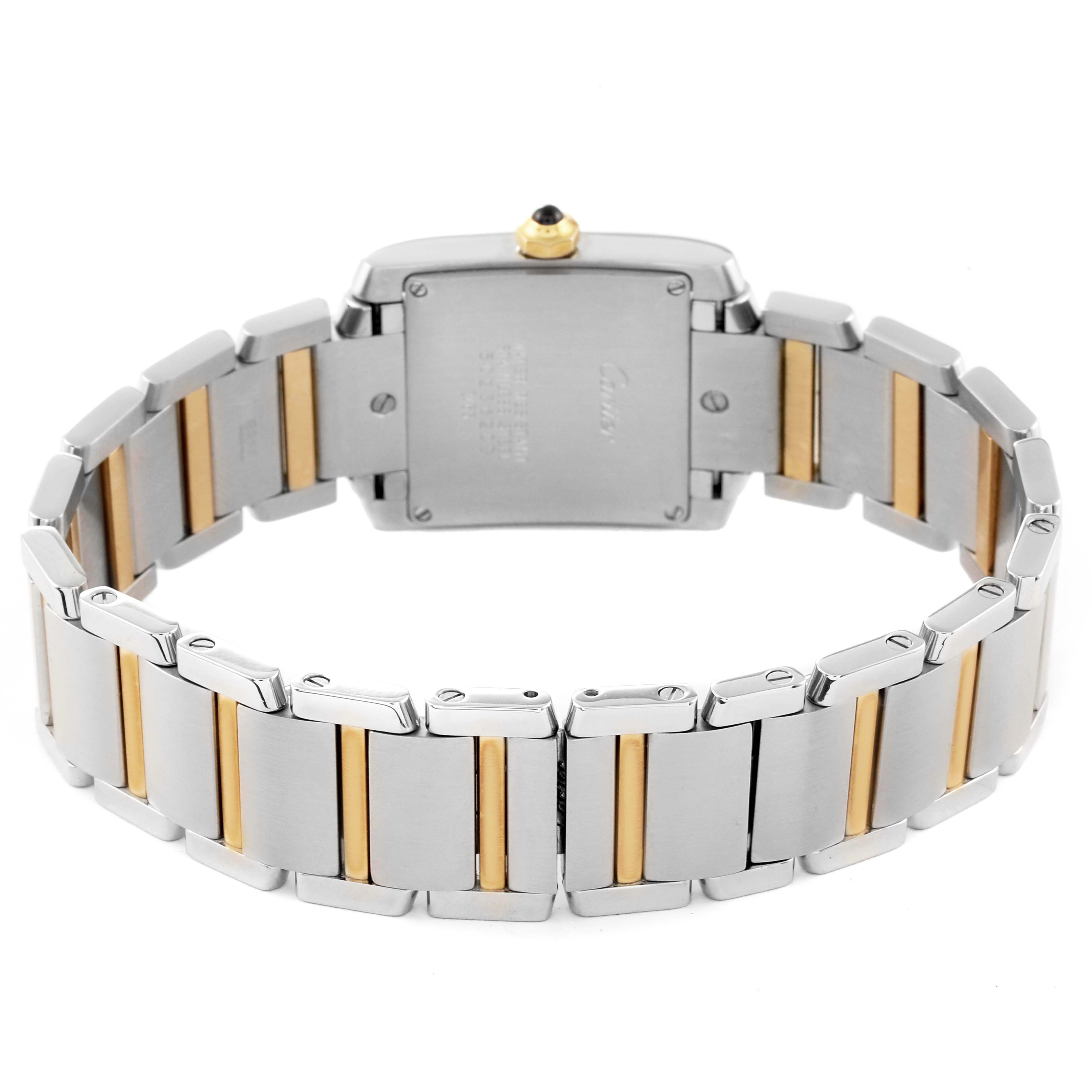 The image shows the back view of a Cartier Tank Française watch, highlighting its metal bracelet with gold accents.