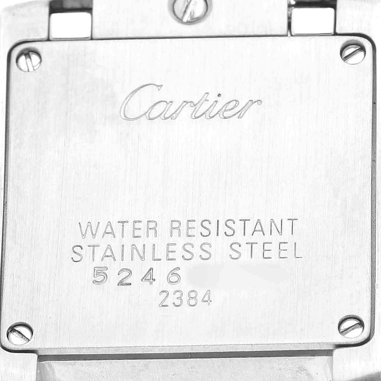 The image shows the back case of the Cartier Tank Française watch, highlighting brand engravings and screw details.