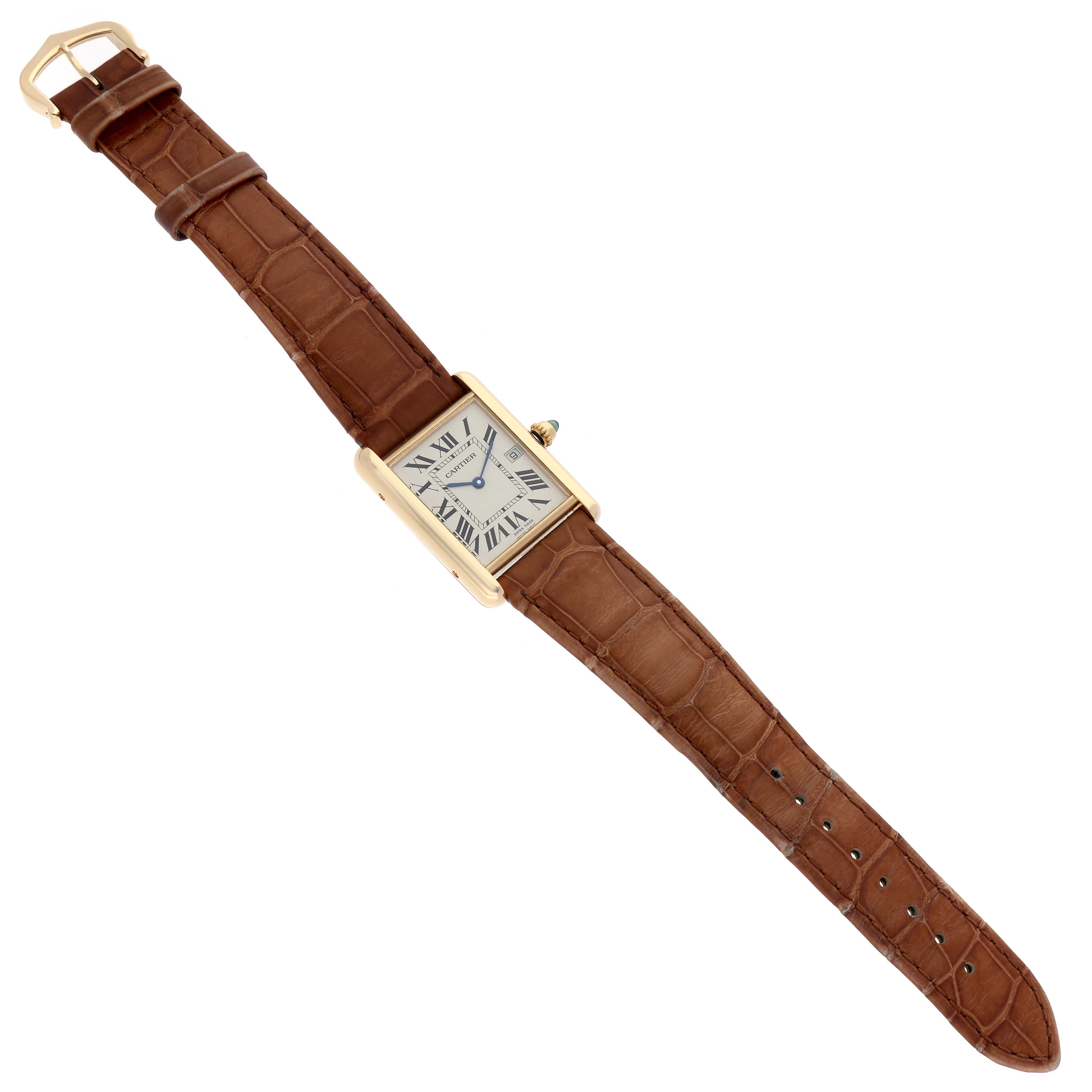 The image shows a Tank Louis watch by Cartier from a top angle, displaying its brown leather strap and rectangular face with Roman numerals.